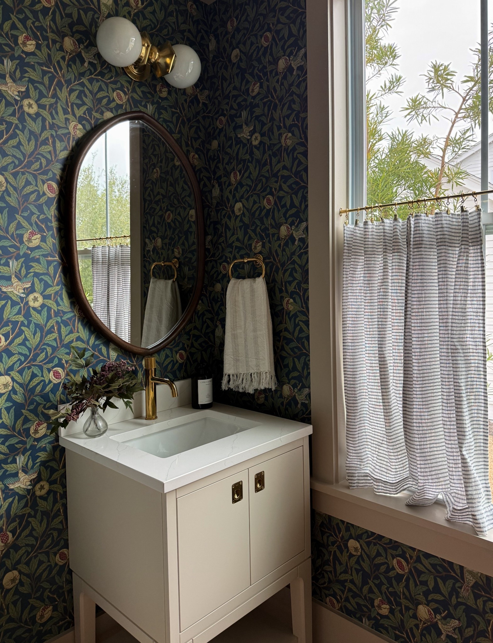 ✨ Moody powder room moment ✨

Loving how this cozy bathroom design came together with a Kohler x Studio McGee vanity, classic Rejuvenation hardware + faucet, and timeless Morris & Co wallpaper. The brass finishes + vintage inspired floral wallpaper create the perfect mix of modern traditional style.

If you’re planning a powder room refresh or bathroom remodel, this combo gives major designer look for a small space — classic, elevated, and full of character.

Shop my bathroom sources + similar finds here 🤍

#ltkhome #ltkstyle #powderroomdesign #bathroomdesign #bathroomremodel #studiomcgee #kohler #rejuvenation #morrisandco #wallpaperdecor #traditionalhome #moderntraditional #moodyinteriors #homedecorideas #bathroominspo #interiordesignideas #smallspacedesign