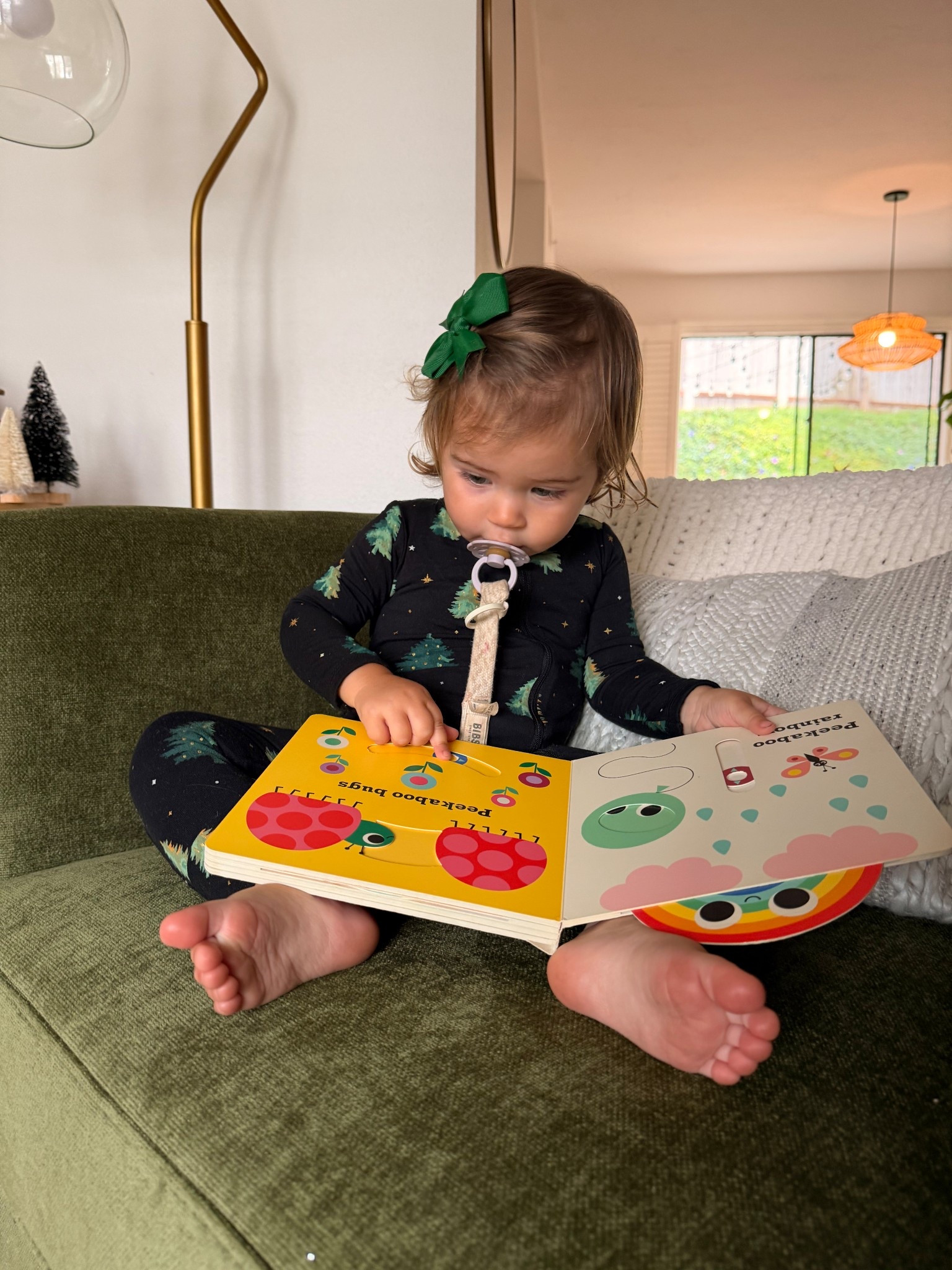 My book obsessed baby 🥹 these peekaboo books have been her fav! Great baby Christmas gift!! And these Christmas pajamas are so precious! Matching ones for her sister too! 