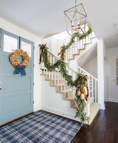 View of our entryway at Christmas in our last house. Items include a pinecone, navy blue plaid rug, large brass bells, velvet ribbon, lantern chandelier and a similar garland. 

#ltkhome #ltkholiday #ltksalealert #ltkunder50 #ltkunder100 #ltkstyletip #ltkseasonal

#LTKHoliday #LTKSeasonal #LTKhome