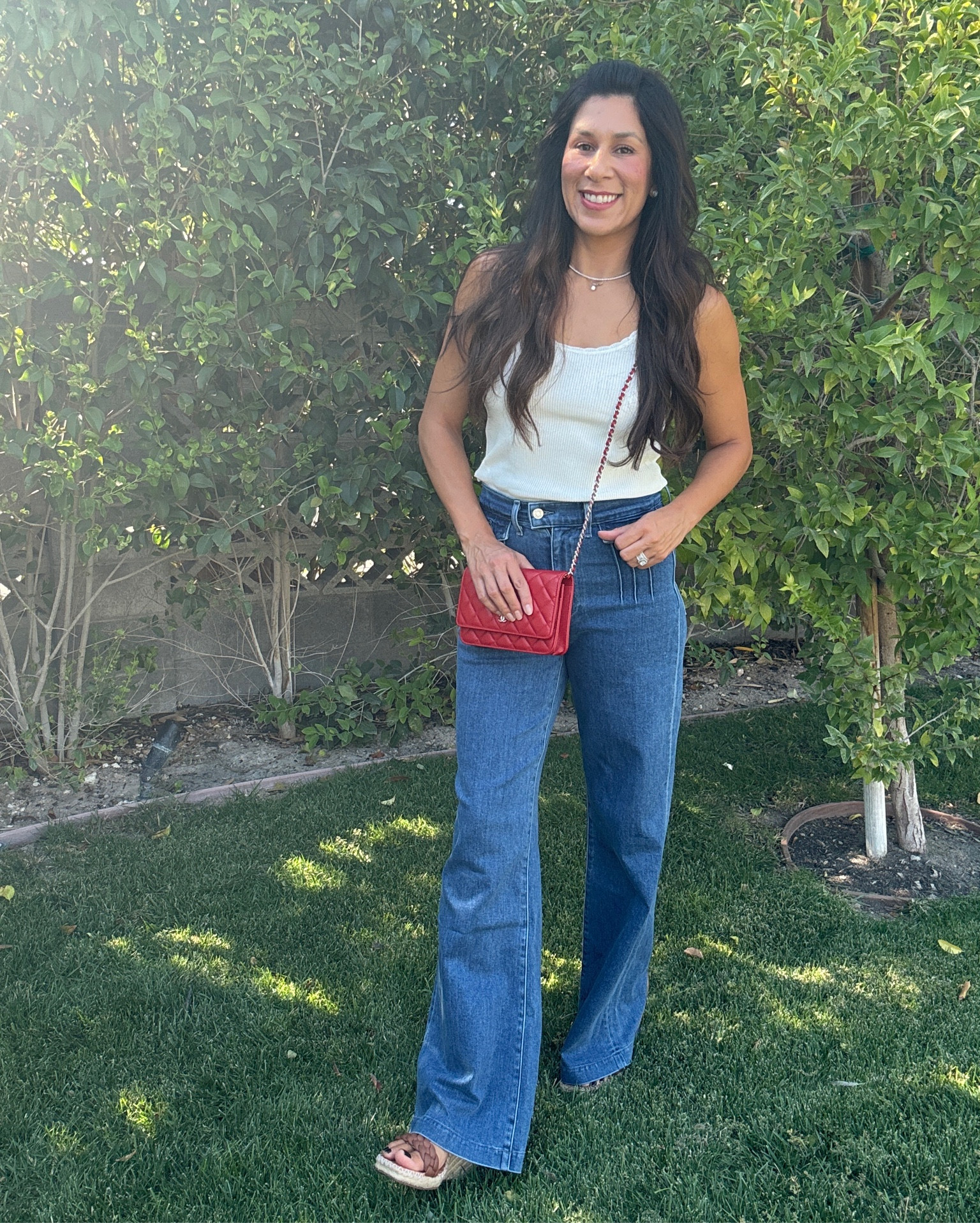 Effortlessly chic in high-waisted denim with front pocket detailing, perfectly paired with a classic white tank. Adding height with comfy wedges and a pop of color with my red crossbody purse. Loving this laid-back yet polished look! ❤️👖👡 #OOTD #DenimDays #CasualChic 

#LTKStyleTip #LTKFindsUnder50 #LTKSeasonal