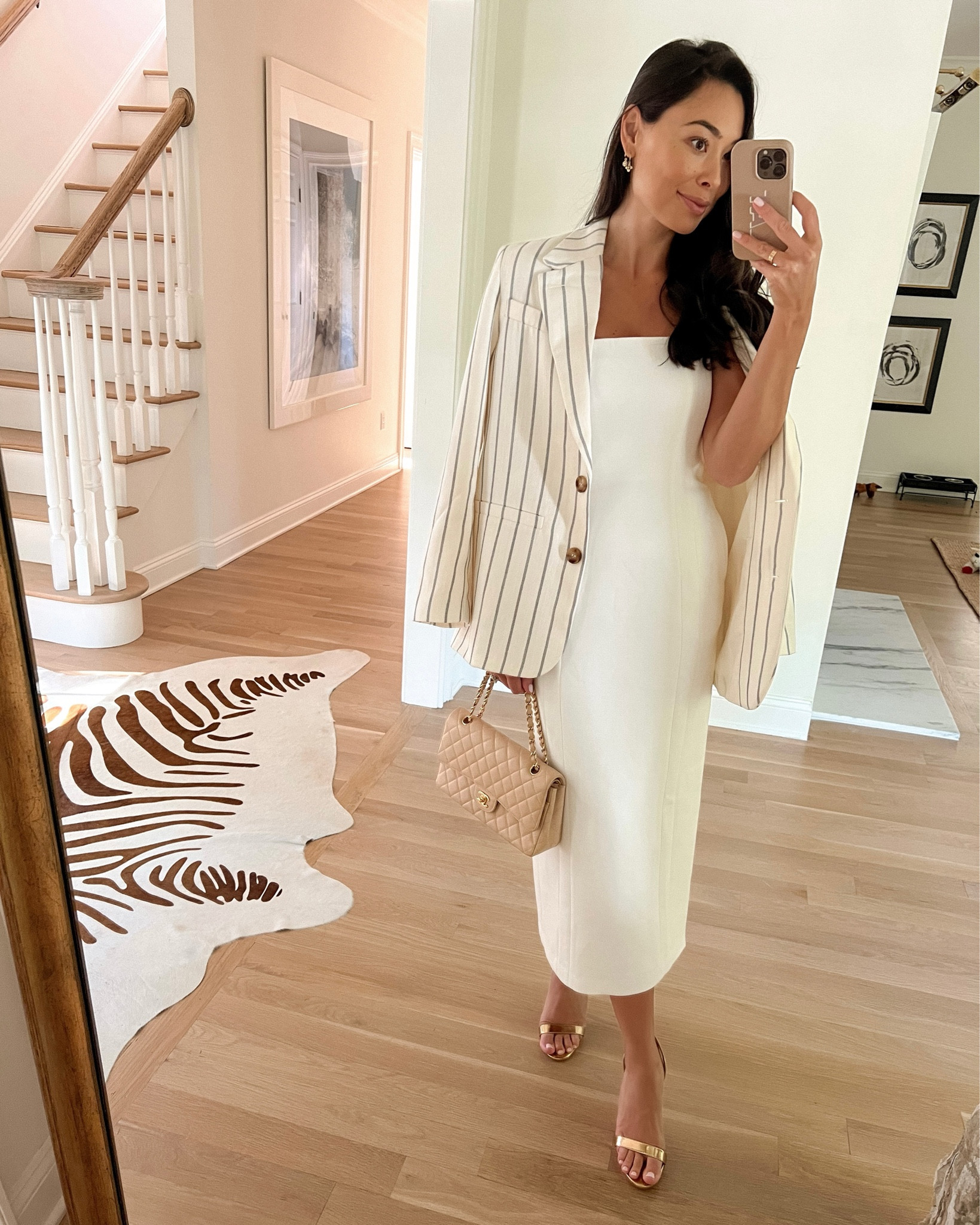 Kat Jamieson wears a white strapless dress, stripe blazer, gold heels and Chanel bag. Classic style, prep, elegant, cocktail, midi dress, workwear, summer. 

#LTKworkwear #LTKshoecrush #LTKSeasonal
