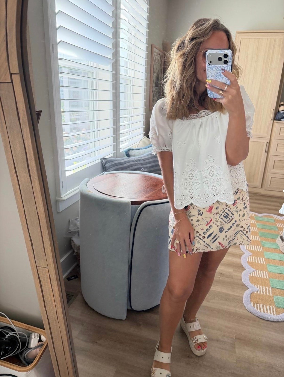 Coastal meets everyday ✨ This eyelet blouse and printed mini skirt are giving effortless end-of-summer style. The perfect outfit for vacation, brunch, beach towns, date night, or just looking put together without overthinking it. Finished with comfy platform sandals you’ll reach for on repeat. 🤍🌊

eyelet blouse, white summer top, printed mini skirt, coastal style, vacation outfit, beach outfit, casual chic, resort wear, platform sandals, feminine outfit, summer fashion, petite style.