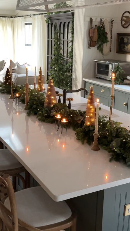 Christmas kitchen island ✨ I like to keep things cozy and clutter-free by hugging all my decor to the center of the island. I stacked the garland on top of each other and tucked the bases of the trees under the garland to save space! I really like how they looked tucked under the garland, it created a cute little forest! For twinkle lights, I LOVE @shopterrain's party pack lights for those tricky spots where bulky battery packs just won't do. They've been my go-to for years in those nooks and crannies needing some shine! All of the decor that I used here is from previous years but I linked lots of similar options on my LTK, linked in my bio! I even found deer tea light dupes!!! 

#ChristmasHome #VintageHome #VintageStyle #ChristmasKitchen #HolidayHome #CozyHomeDecor #ChristmasDecor #ChristmasIslandDecor #WinterHome #CozyVibes #FestiveDecor #SeasonalStyle #HomeInspo #LTKunder50 #TwinkleLights #DeckTheHalls

#LTKSeasonal #LTKHoliday #LTKhome