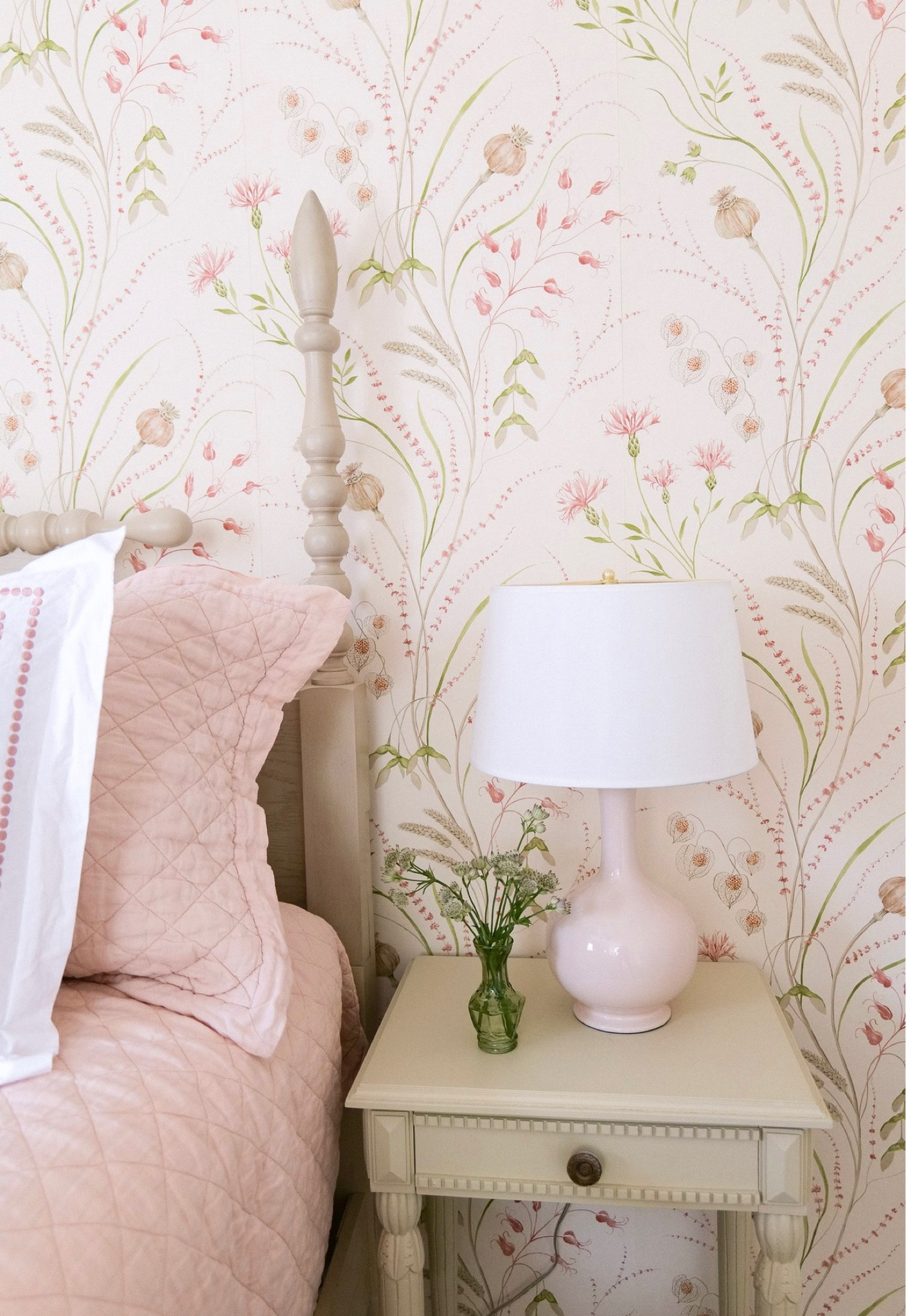 We started off by giving the room a big bold makeover by updating the neutral wall color the room previously had by installing a beautiful wallpaper. Along with the wallpaper we installed, we also added a few statement pieces to create visual interest in the room and to give it a cozy and inviting feel. We went with fresh white linens and pops of pinks and greens in the pillows to bring color and texture to the space. The bed is dressed by a Pottery Barn duvet cover with small pink detail that matches the Pottery Barn quilt, quilt euro shams, and curtains. These all added pops of pink that matches the wallpaper perfectly. To complete the bedside look, I found an antique style nightstand that was small enough to fit the space and also close enough in style to match the beautiful bed. A pink lamp with white shade was added for a subtle pink touch and the white shade tied into the bedding nicely. Shockingly, I found the Bed for this room on Amazon and am so in love with it. I will link below if you are looking for a great quality bed that is budget-friendly and that can also be functional with so many color schemes. 

#LTKunder50 #LTKhome #LTKunder100