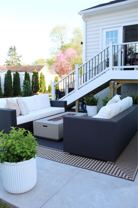 Outdoor sofas, outdoor rugs, concrete fire pit, planters 

#LTKHome #LTKStyleTip #LTKSeasonal
