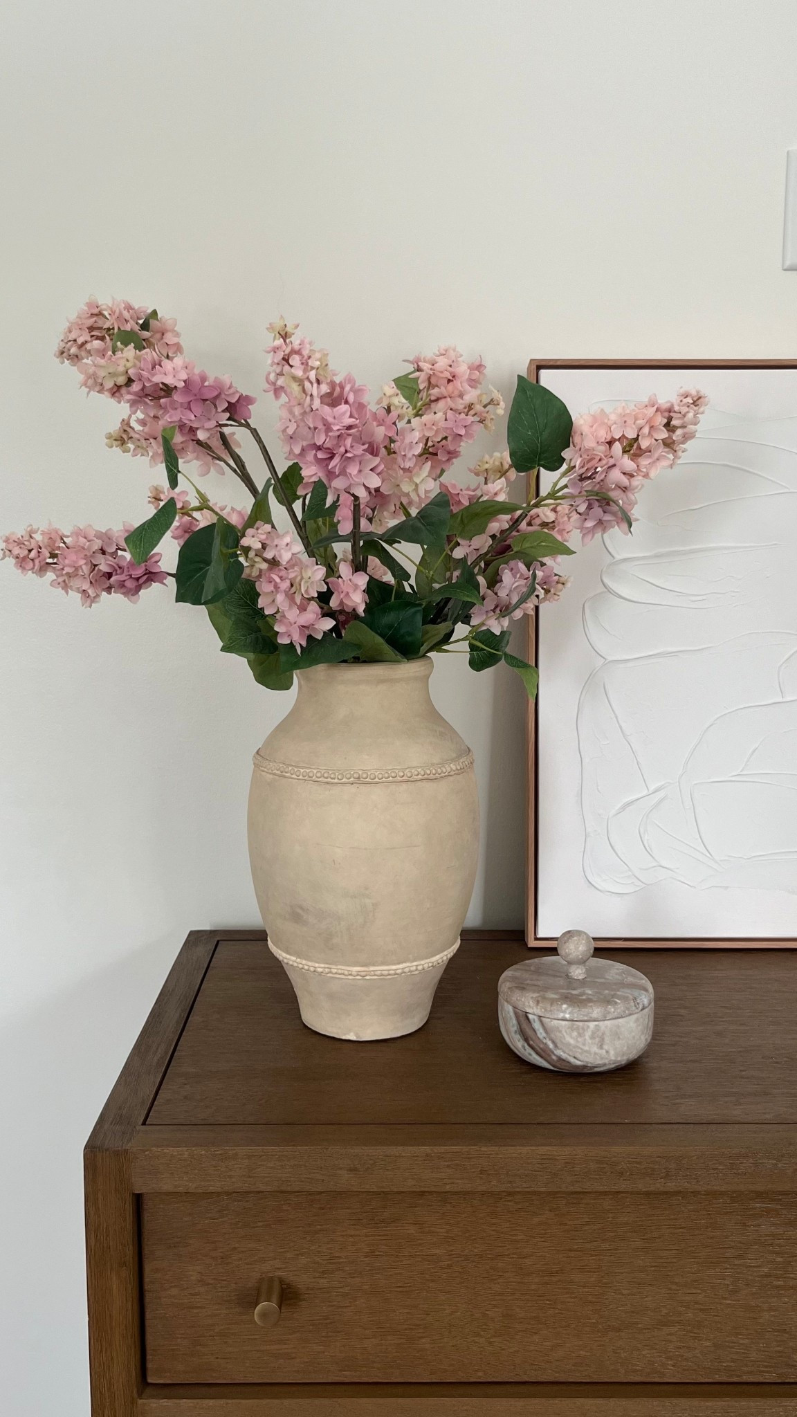 Bedroom dresser home decor styling ✨ Pottery Barn faux lilac floral stems, large vase, marble dish, white neutral wall art, Crate and Barrel keane driftwood dresser. 

Home decor
Master bedroom
Decor inspiration 
Target find


#LTKHome