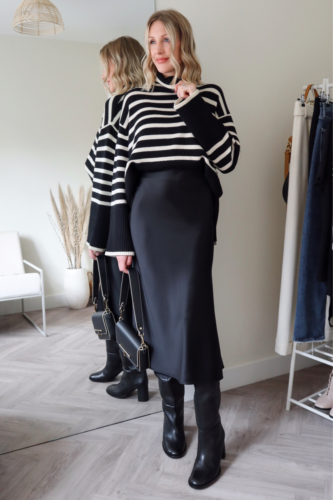 Knee boots - satin skirt - striped knit - black and white outfit #stripes #knitwear #kneeboots #toteme 

#LTKeurope #LTKshoecrush #LTKSeasonal