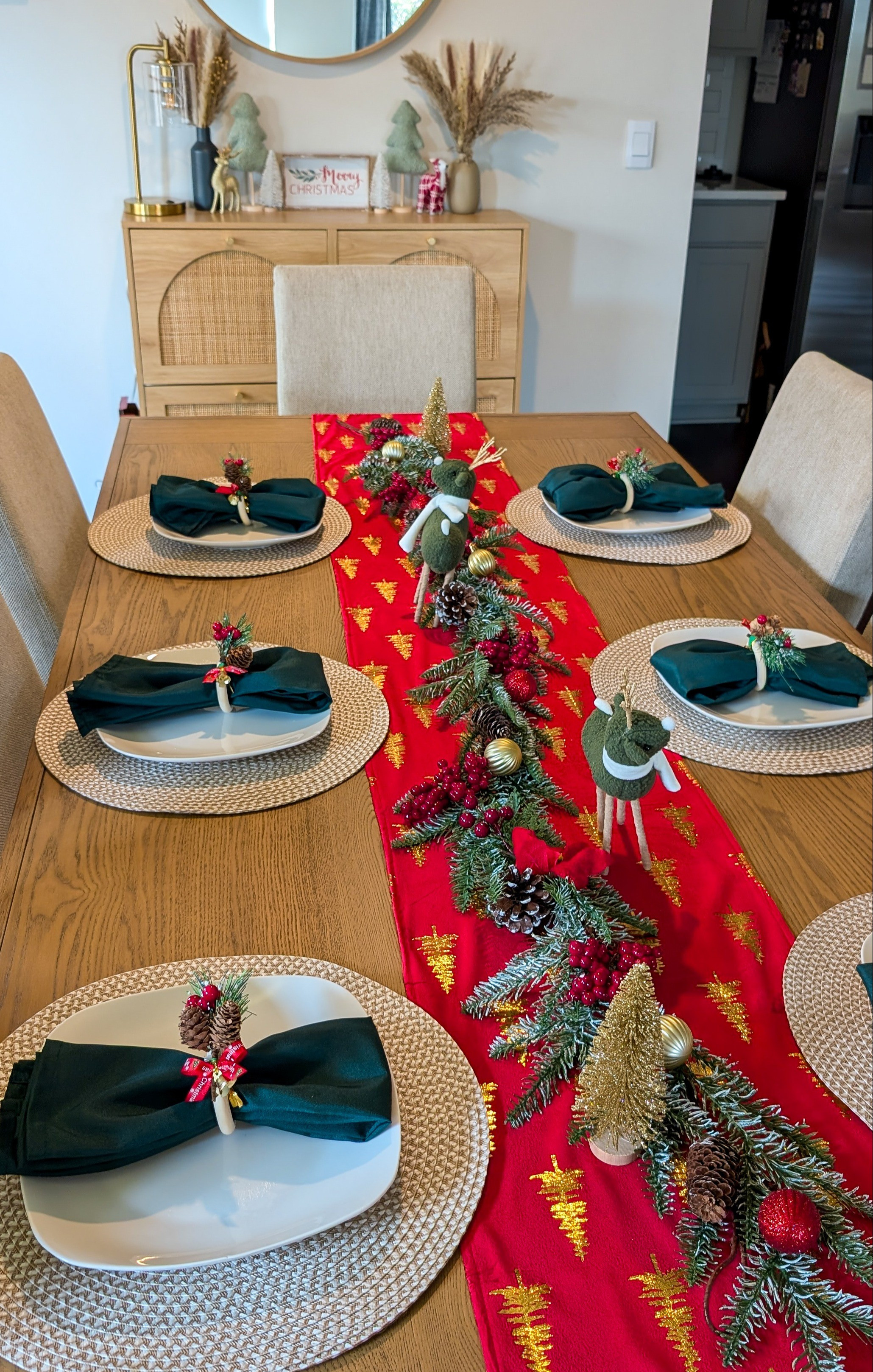 Christmas holiday table setting. Red table runner, garland, place mats, cloth napkins, napkin rings.

#LTKHoliday #LTKHome #LTKFindsUnder50