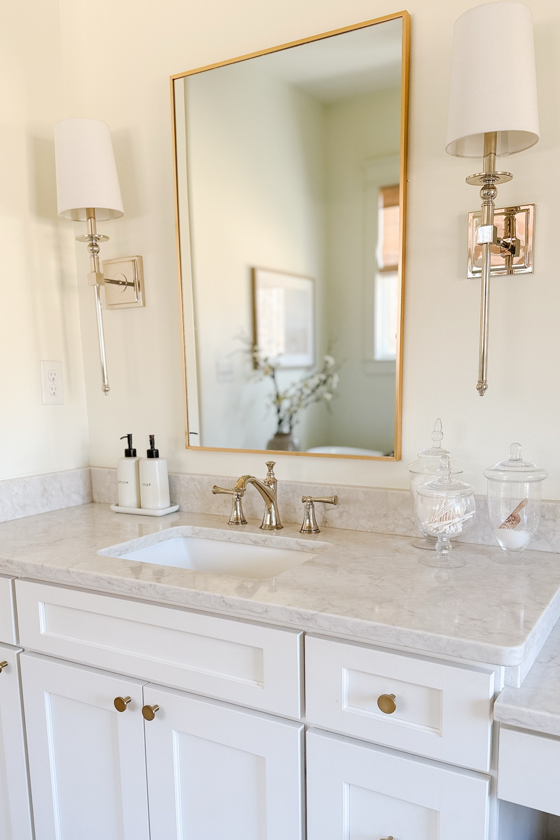 Primary Bathroom Views ✨light and airy white bathroom. Our sconces have been discontinued but I’ll link similar. The mirror and apothecary jars are from Amazon. The faucet is Brizo Baliza in polished nickel. 

#LTKHome
