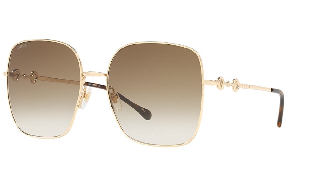 Introducing Gucci GG0879S sunglasses, a perfect fusion of style and substance. The gold metal frame with brown gradient lenses exudes sophistication, while the rectangle shape adds an element of timeless elegance. These iconic shades embody the essence of craftsmanship and cutting-edge design that has defined Gucci's legacy for over 90 years.