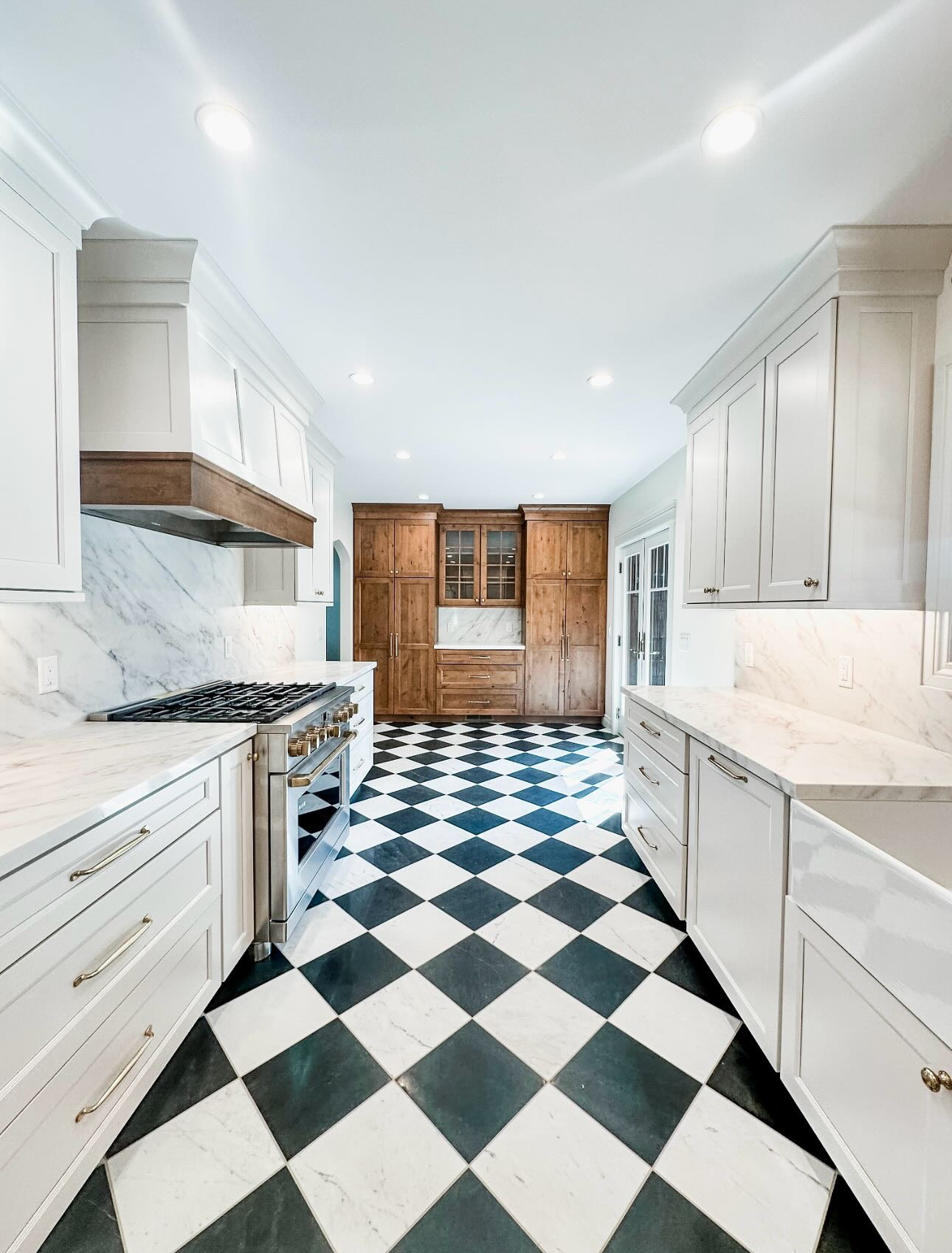 Kitchen Goals Unlocked with this timeless kitchen transformation—where modern functionality meets classic charm.

From the bold black & white checkerboard floors that ground the space with personality, to the soft linen white cabinetry topped with quartz that keeps everything bright and airy—this kitchen is all about balance.

Details worth swooning over:
-Seamless built-in paneled appliances for a polished look
-A professional-grade range framed by custom hood with wood accents
-Quartz counters + backsplash that flow effortlessly for a luxe touch
-Statement lighting and brass hardware that tie it all together

It’s proof that clean lines and thoughtful contrasts never go out of style.

Would you go bold with checkerboard floors in your kitchen?

@thetileshop @capitalgraniteinc @durasupreme @potterybarn  #KitchenDesign #InteriorInspo #ModernClassic #CheckerboardFloor #TimelessStyle #DreamKitchen #InteriorDesign