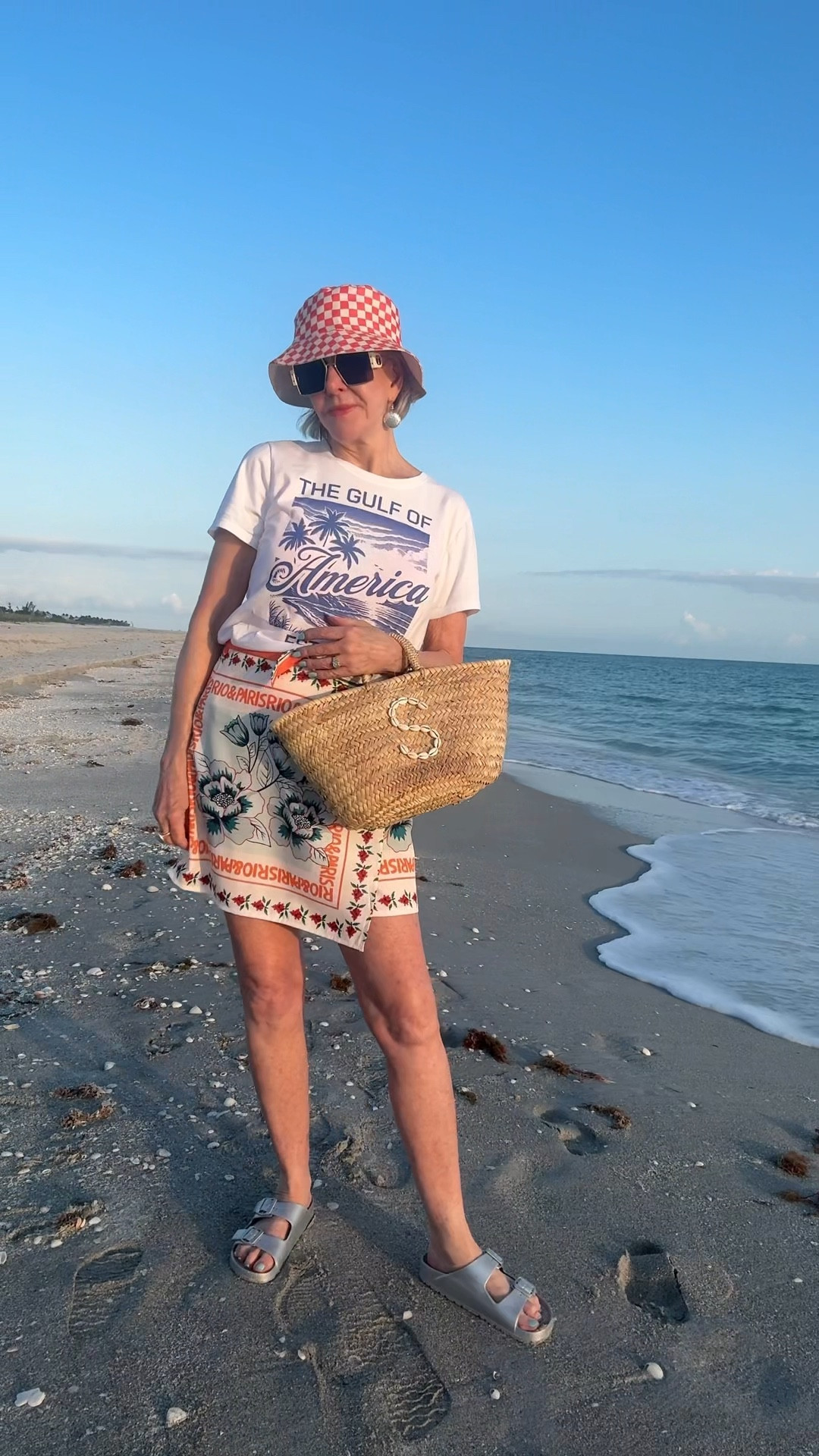  Floral Wrap Short Skirt Tie Side High Waist A Line Beach Vacation Boho Mini Skirt. Size up at least one size. I am wearing a large. Comes in 7 prints
A cute checked bucket hat comes in other colors as well.
Straw tote. Customize to fit you
Gulf of America tee. Wearing a medium. Size up if you want a looser fit. 

#LTKOver40 #LTKStyleTip #LTKTravel