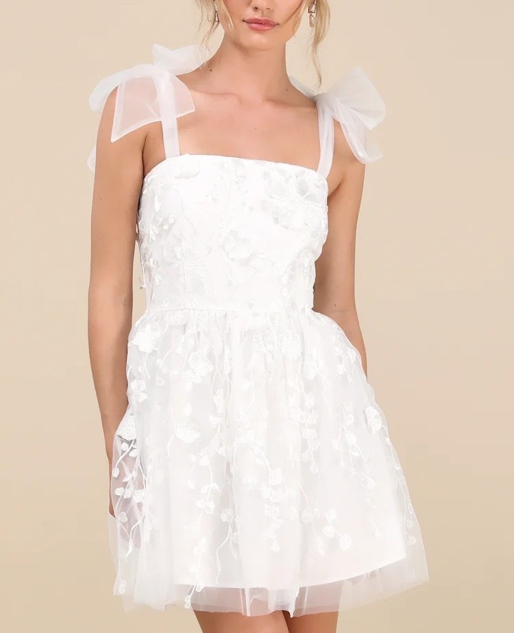 Bridal-inspired, but made for every moment — a white mini dress that feels timeless, feminine, and beautifully detailed. Ideal for vacations, bridal showers, and graduation. Under $100.

Keywords:

* white floral mini dress
* 3D floral dress
* applique mini dress
* white summer dress
* tie strap dress
* feminine mini dress
* romantic dress
* bridal mini dress
* bridal shower dress
* bachelorette outfit
* brunch outfit
* garden party dress
* summer outfit ideas
* vacation dress
* graduation dress
* daytime event dress
* feminine outfit
* romantic aesthetic
* soft girl aesthetic
* european summer style
* feminine fashion
* dreamy outfit
* soft luxury style
* delicate details
* airy elegance

#LTKootd #LTKWedding #LTKgrwm