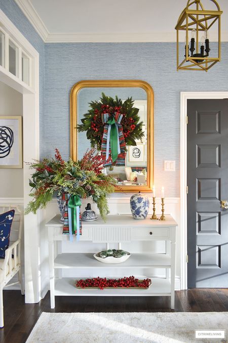 Create an elegant and traditional  Christmas entryway with lush greenery, plaid and satin ribbon and festive red berries 

#LTKhome #LTKstyletip #LTKSeasonal