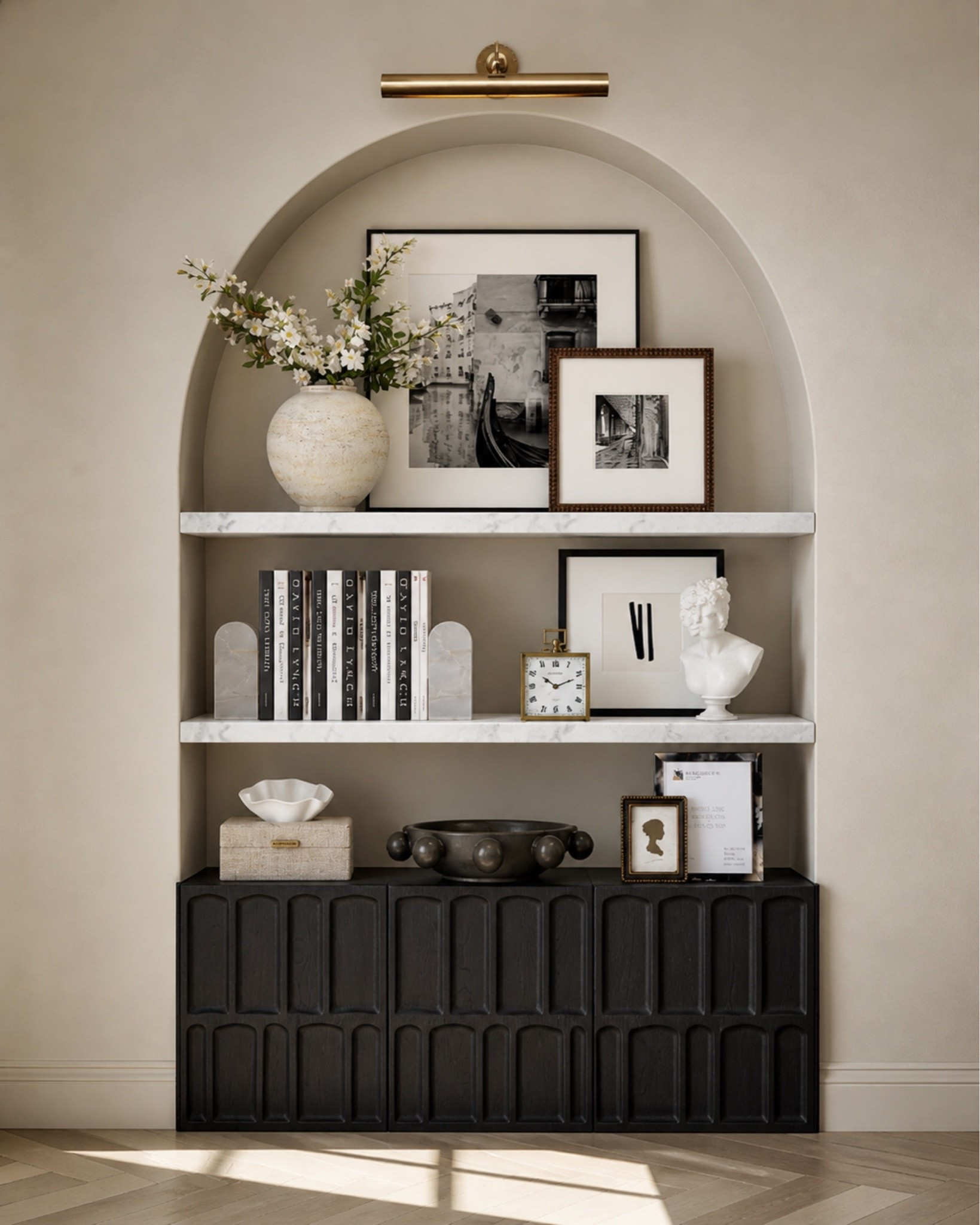 This is such an easy way to make a blank wall feel finished and intentional. A dark cabinet adds hidden storage, marble shelves keep it polished, and simple styling pieces like framed art, books, a vase, and a picture light make the whole space feel custom without needing a full renovation.

Perfect for an entryway, living room, dining room, or any little wall that needs more storage and style.

This post contains affiliate links, and I may earn a small commission from purchases at no additional cost to you.

#LTKHome