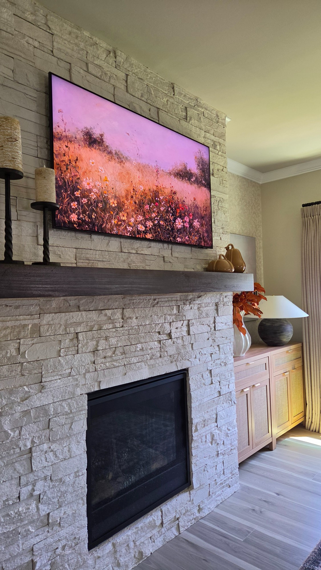 Warm candlelight, glossy seasonal accents, and glowing sunset frame art bring cozy fall ambiance to the living room. Simple, balanced pieces make this stone fireplace feel effortlessly ready for autumn.#FallDecor #MantleDecor #FireplaceStyling #CozyHome

#LTKSeasonal #LTKHome