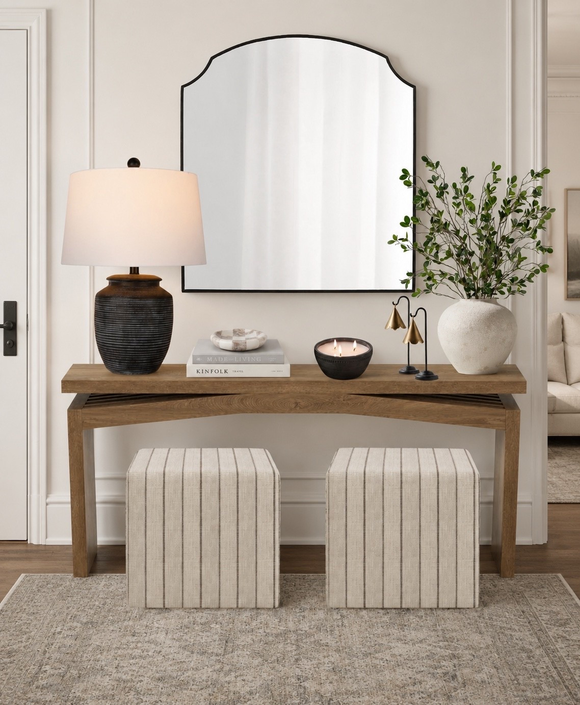 Modern organic foyer. 

Magnolia home / wayfair finds / console table / ottoman cubes / joss and main / black lamp / rustic white vase / faux stems / bells / crate and barrel mirror / marble bowl / trinket bowl / candle pot / loloi rug / Christmas Loves Julia / transitional design