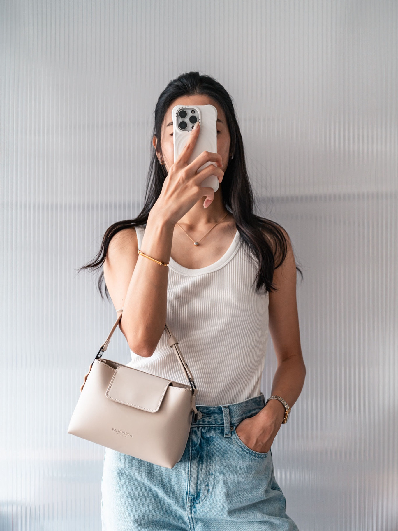 Summer OOTD: white ribbed tank top, light blue wide-leg jeans, ecru top handle bag, white phone case, gold vermeil jewellery

#LTKbag #LTKasia
