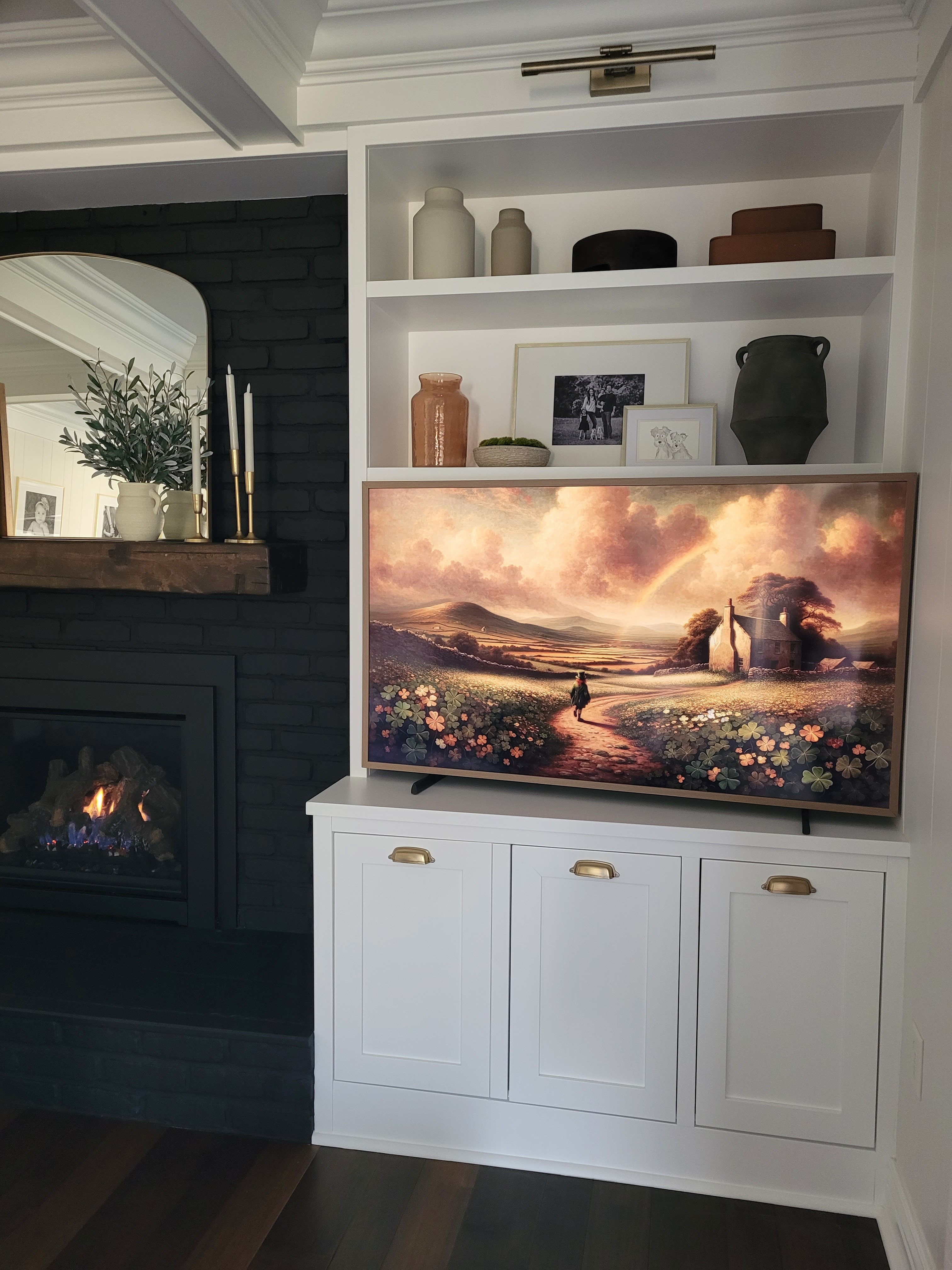 Spring living room inspo with St. Patrick's Day frame tv art on our built ins, shelf styling, and faux olive plant mantle decor,  st Patty's,  spring decor,  gallery light, black fireplace

#LTKHome