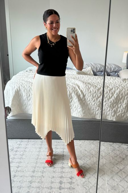 Summer office outfit that also takes me to date night later! A cropped black tank sits just at the waistband of a high-waisted pleated chiffon skirt. I paired it with a pop of color in low block heels and a ton of gold jewelry - chunky charm necklace, earrings stack, and my tennis bracelet  

#LTKMidsize #LTKSeasonal #LTKWorkwear