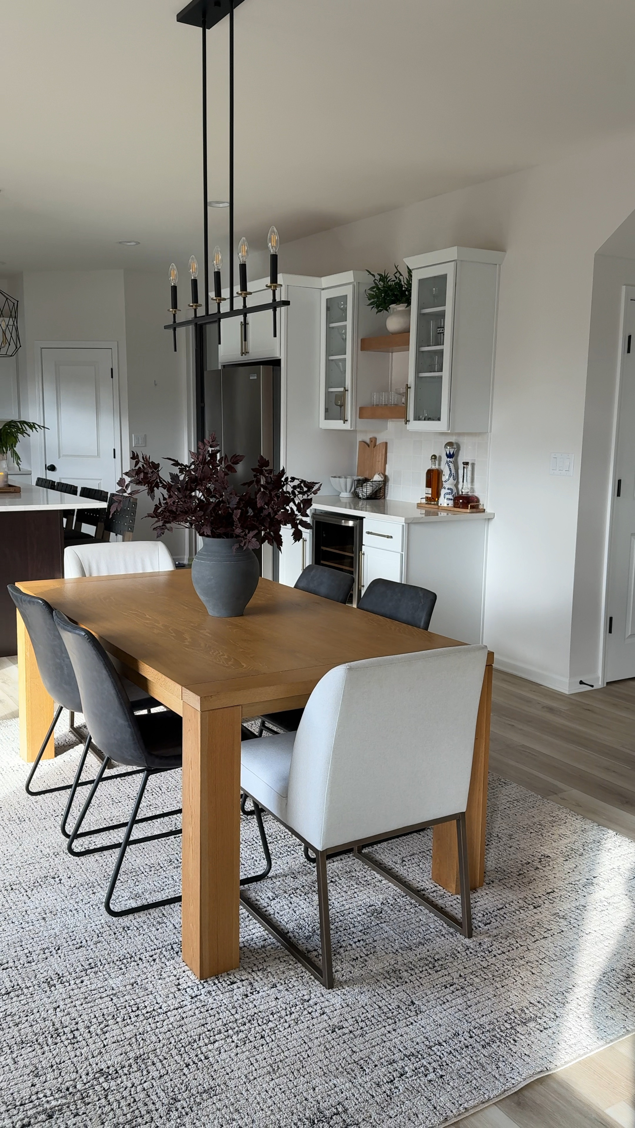 Dining area.
Table is an older version from West Elm, I linked a couple similar options. White chairs and from Amazon but no longer available, I linked a similar option. Dark gray chairs are Target. I have 3 stems in the vase. Area rug is 7-10x10
Home refresh, dining room 

#LTKHome