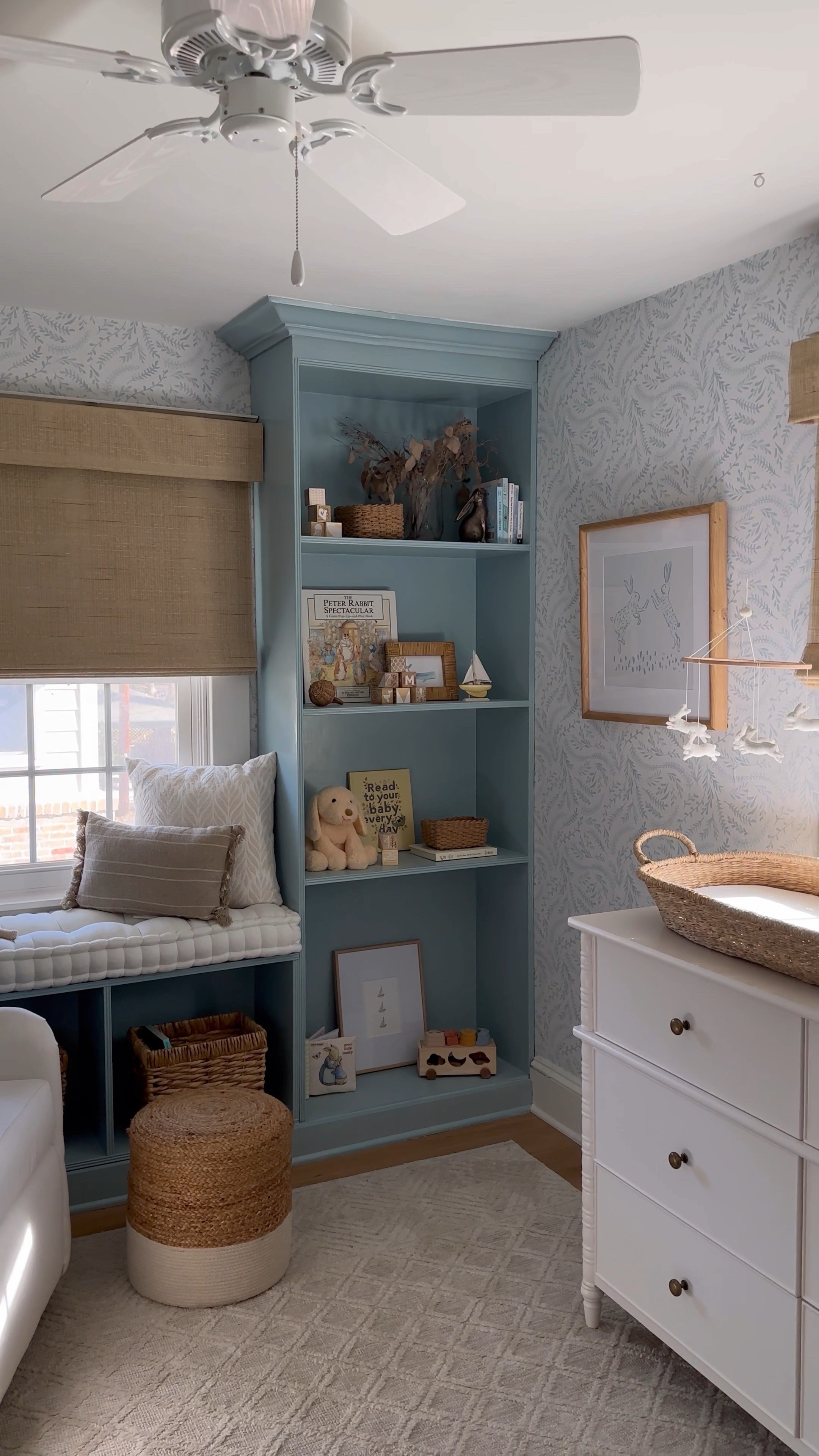 What started as an empty room…what space have you totally transformed? ✨ Get all the details on this space + shop at the link in bio by scrolling to search “Nursery”
•
•
•

baby nursery, blue wallpaper, white crib, glider, neutral loloi rug, soft rug, Roman shades, nursery design, nursery decor, woven hamper, crib skirt, gender neutral nursery, calm nursery, pouf, brass mirror, nursery shelf decor, changing table, woven changing basket, rabbit mobile, baby mobile, hutch
#nursery #nurserydecor #nurseryinspo #nurserydesign #nurseryinspiration #babyroomdecor #babyroom #neutralnursery #genderneutralnursery #homedecor #wallpaperwednesday #homedesign #potterybarn #glider #crib #maternityshoot #maternityphotography #ltkhump #ltkbaby 
#pregnancyannouncement 
#liketkit  Shelf decor 

#LTKstyletip #LTKsalealert #LTKhome