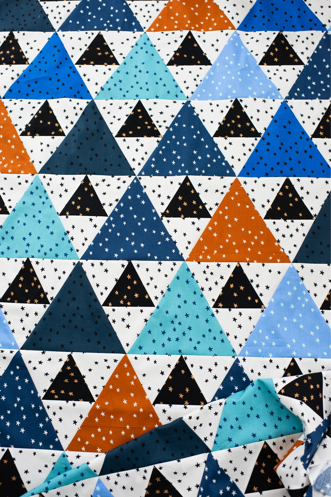 Triangle Peaks quilt pattern using Ruby Star Society Starry Fabrics.  I recommend a 60 degree triangle ruler for this one.  