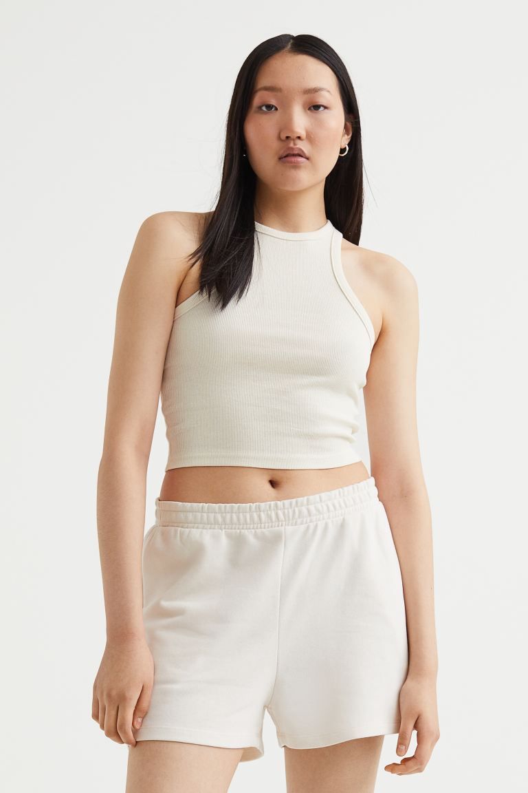 Conscious choice  Fitted, crop tank top in ribbed cotton jersey. Narrow cut at top with a racer b... | H&M (US + CA)