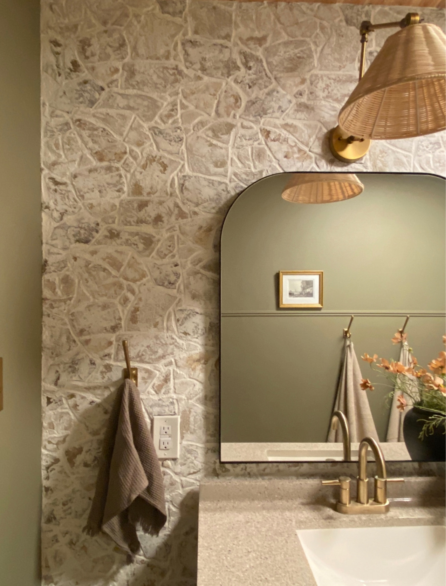 Faux rock wall sources 
I used the caulk as an adhesive to adhere the panels to the wall then I used a grout bag to pipe the Alex plus Spackling between the stones and spread around. I then used my finger to accentuate the lines in between the stones and used a washcloth to dab them while still wet and provide more texture. 

#LTKhome