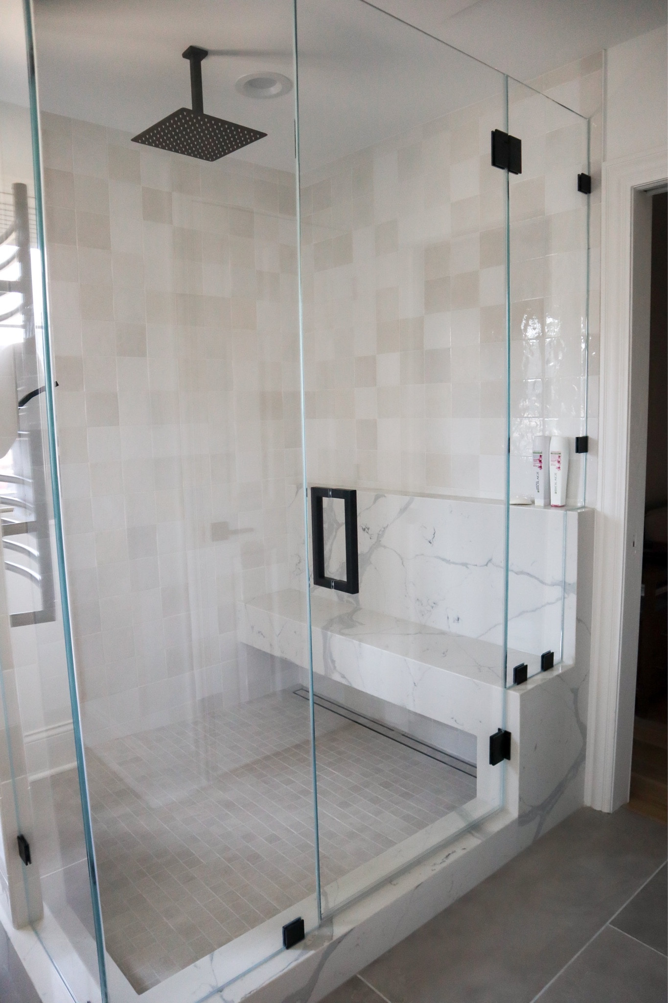 Master shower tile and quartz bench black accents 

#LTKFind #LTKfamily #LTKhome