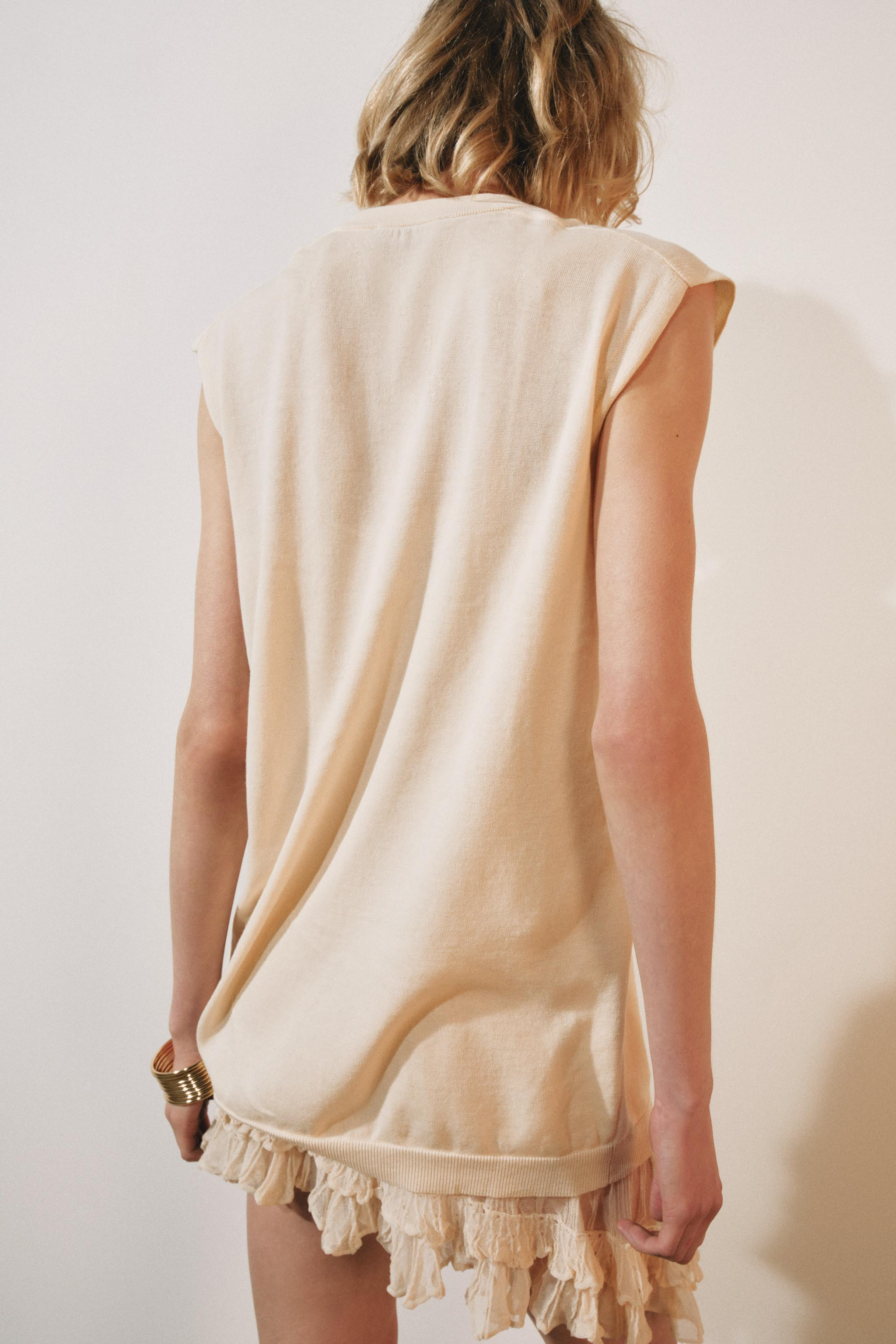V-neck waistcoat with sleeveless design. Asymmetric hem with contrast fabric. | Zara UK