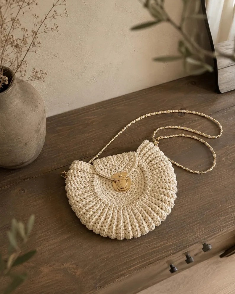 The most unique bag I’ve seen all summer and there’s only ONE left 😭🤍 This handmade crochet crossbody is 100% cotton, fully lined, and that crescent shape with the gold chain strap?? Absolutely stunning. This is the kind of piece you find and never see again! 

#CrochetBag #CrochetCrossbody #HandmadeBag #BohoBag #CrossbodyPurse #BohoChic #EtsyFinds #EtsyFashion #HandmadeHandbag #CottonBag #ChainStrapBag #CrescentBag #UniqueHandbag #SummerBag #SummerAccessories #BohoAccessories #ArtisanBag #EtsySeller #StyleInspo #BagOfTheDay #FashionFinds #LTKfinds #LTKbag #LTKstyletip #LTKunder500