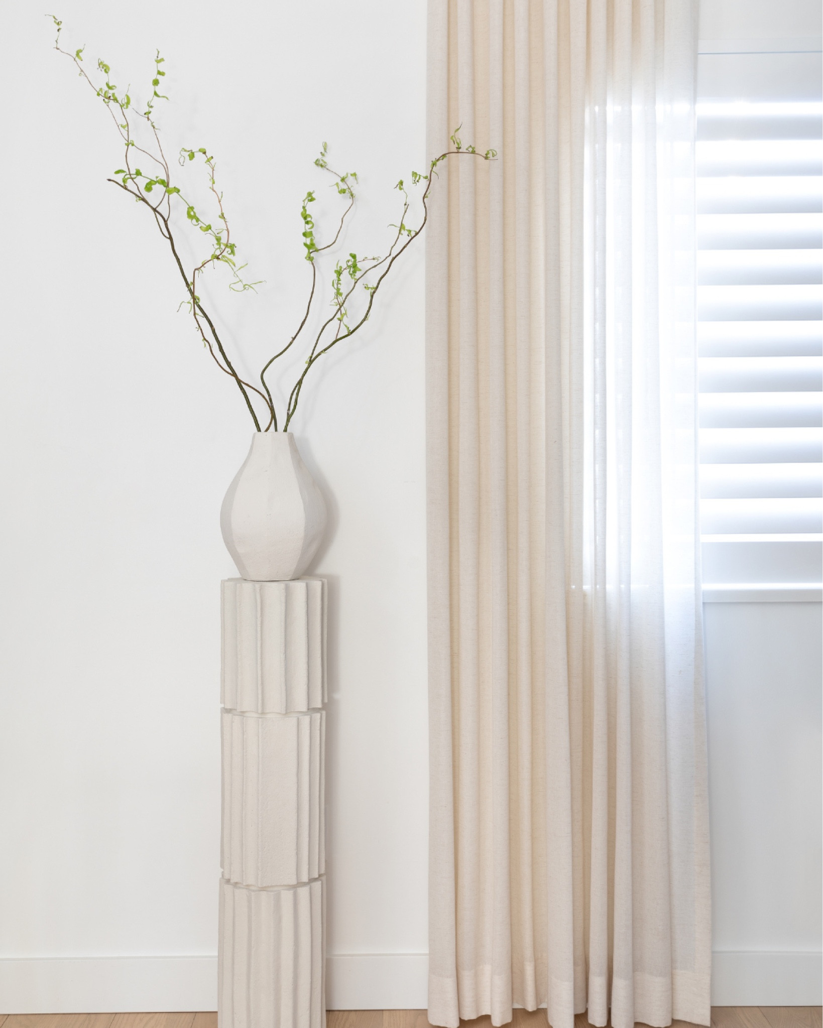 Organic modern decor. Pedestal styling. Athena Calderone for Crate & Barrel

Textured vase. Dried branches. Window drapes. White shutters.  Sculptural pedestal  

#LTKstyletip #LTKhome #LTKunder50