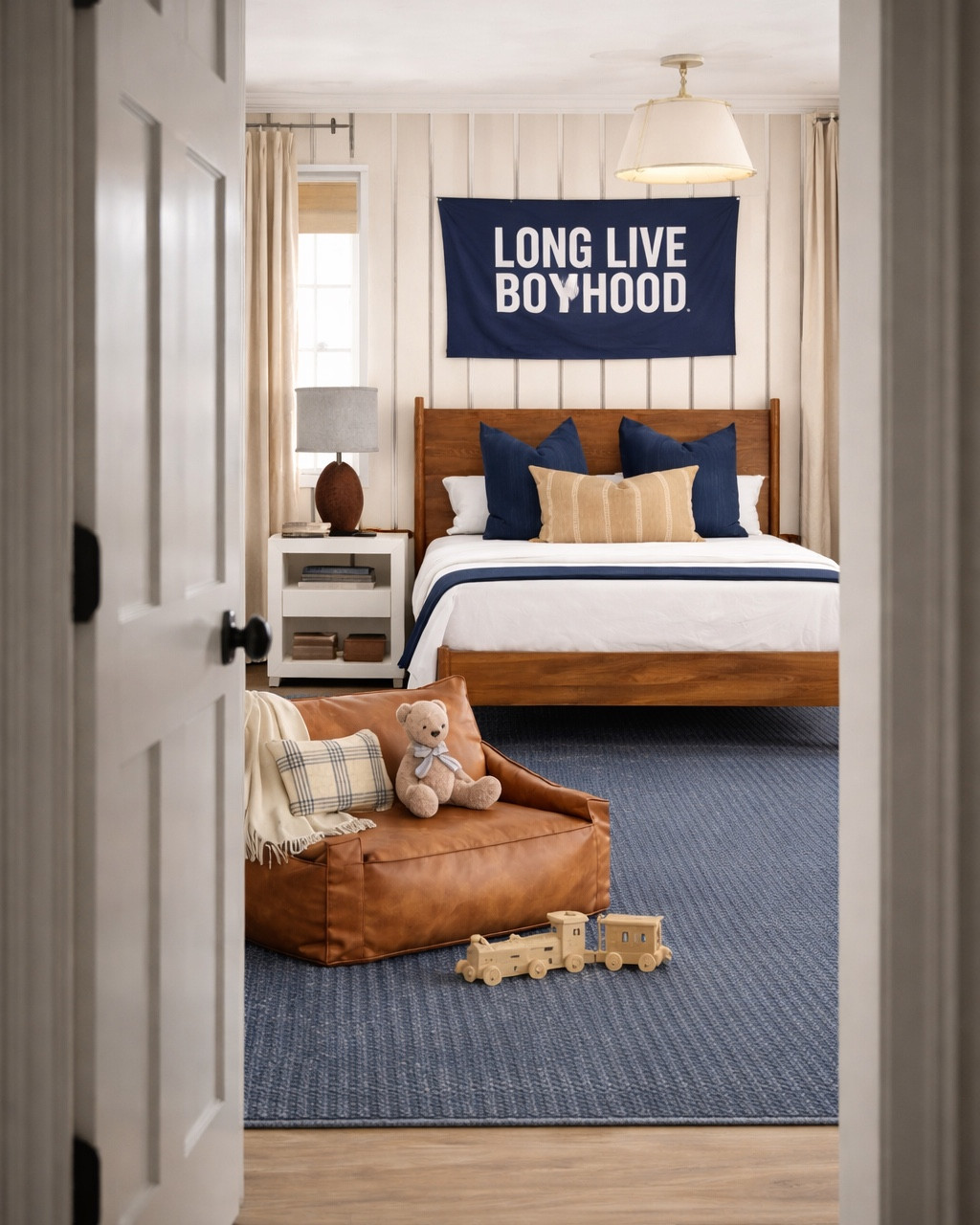 Classic boys bedroom design with a modern traditional feel 🤍

This space mixes warm wood furniture, navy blue accents, and soft neutral bedding for a timeless boys room that can grow with him for years. The striped wallpaper, “long live boyhood” wall banner, and layered pillows create a cozy yet tailored look that feels elevated but still playful.

Sharing all the details including the upholstered bed, wood bed frame, white nightstands, table lamps, navy area rug, leather lounge chair, boys room wall decor, and styling pieces to recreate this classic boys bedroom design in your own home.


#LTKHome #LTKBaby #LTKKids