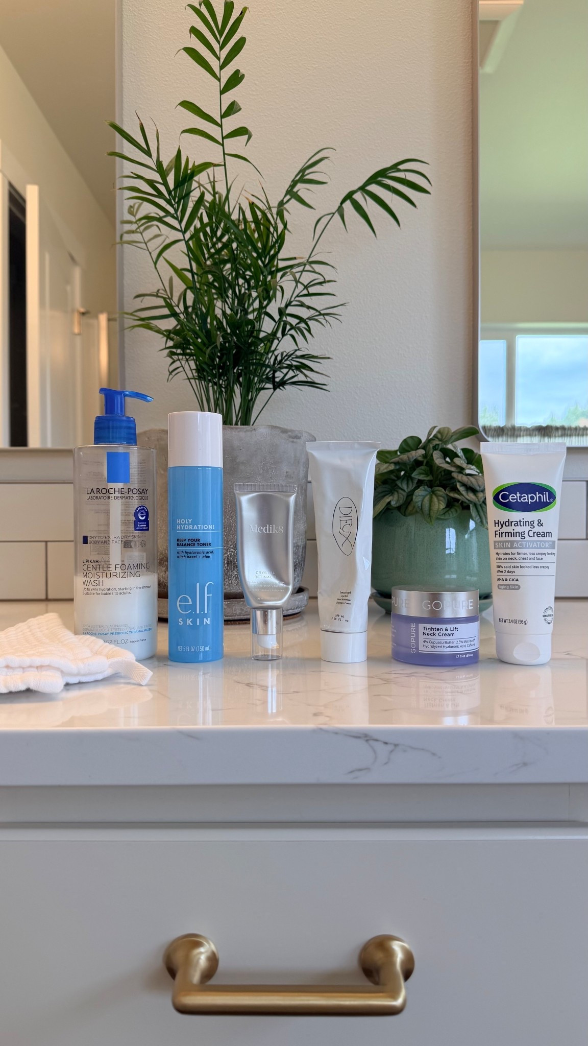 My nighttime beauty routine is something I take really seriously and these are all the products currently sitting on my bathroom counter 🌙✨ Everything is linked! I start with the La Roche-Posay Lipikar AP+ Gentle Foaming Moisturizing Wash and my favorite organic gauze washcloths which are so soft and gentle. Then I follow with the e.l.f. Keep Your Balance Toner, my Crystal Retinal 3 which I am almost finished with before moving up to the Crystal Retinal 6, and the Instant Angel Lipid-Rich Firming Moisturizer on my face. I use the Cetaphil Skin Activator Hydrating and Firming Cream on the backs of my hands because that is an area I think so many of us forget about, and the goPure Tighten and Lift Neck and Chest Cream on my neck every single night. A consistent nighttime routine has made such a difference for my skin and I love every single one of these products. Everything is linked! 🛒 

 #LTKselfcare #LTKOver40 #LTKBeauty