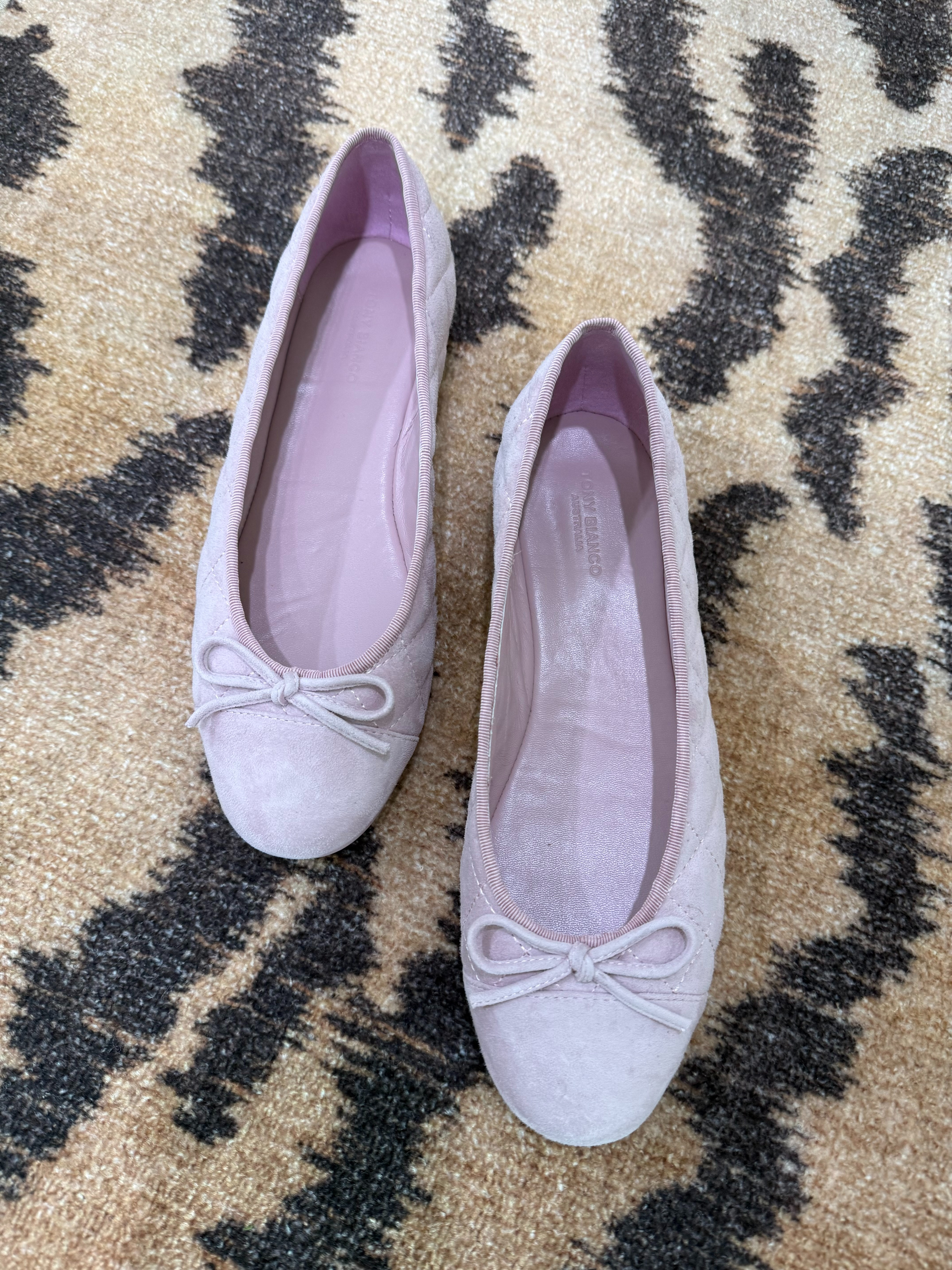 The ballet flat is back, and I'm not mad about it.

Tony Bianco nailed the soft lilac suede — the little bow, the quilted toe, the kind of shoe that makes jeans look put-together and a dress look intentional. It's the flat that does the work of a heel without asking your feet to suffer for it.

Grab a pair before they're gone. 🩰 

 #shoes
