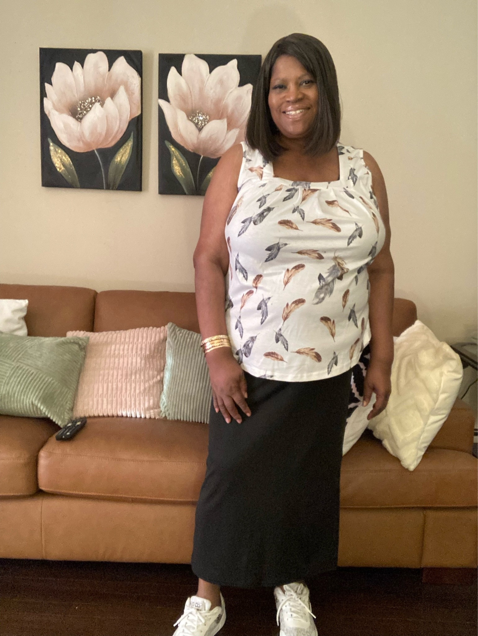 Plus size feather print tank, long black skirt, white sneakers with gold bangle bracelets.

#LTKootd #LTKOver40
