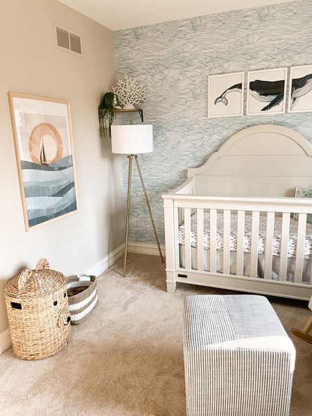 Create a serene oasis for your baby boy with an 🌊ocean-inspired nursery. Adorn the walls with a mesmerizing ocean wave wallpaper, subtly incorporating a Jonah and the whale theme for my little Jonah, evoking a sense of adventure and wonder. Enhance the ambiance with captivating sunset artwork, casting a warm and soothing glow, while a tripod lamp adds a touch of contemporary flair. Complete the look with a charming farmhouse style crib, combining comfort and rustic charm, ensuring your little one's space is both cozy and stylish.

#LTKhome #LTKbaby #LTKbump
