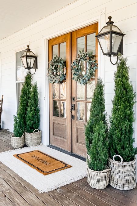 Winter Front Porch! Love these gorgeous cedar trees! I have the 3’ 5’ and 6’ and the quality is so good! They’ve been outside for almost two years! Faux artificial and silk indoor outdoor trees plants and flowers double layered jute rug and doormat eucalyptus berry wreaths rattan resin baskets front porch and door decor home accents spring front doors evergreen trees outdoor wall sconce lantern light fixtures

#LTKstyletip #LTKMostLoved #LTKhome