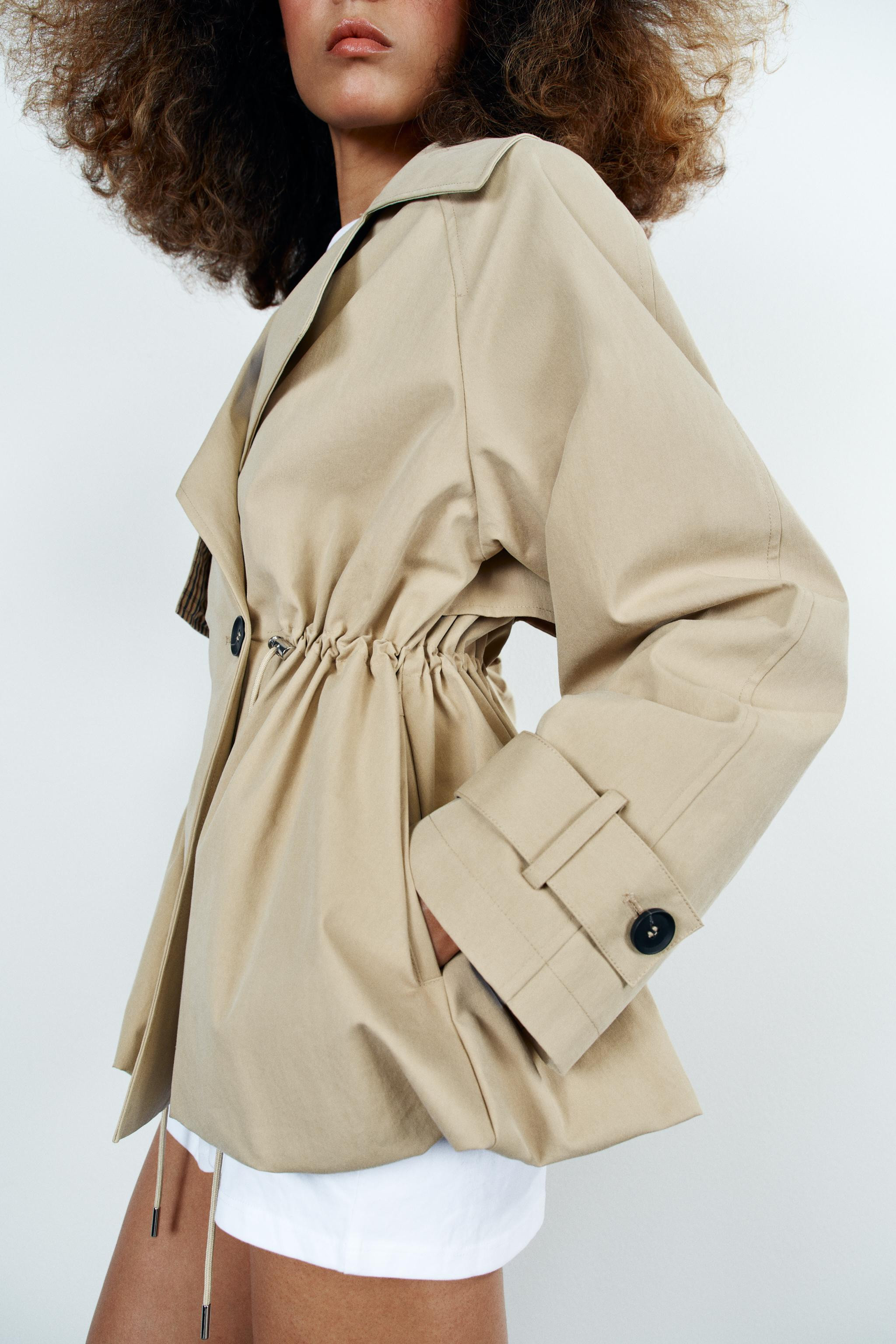 Model height: 174 cmTrench-style jacket featuring a lapel collar and long sleeves finished with t... | Zara UK