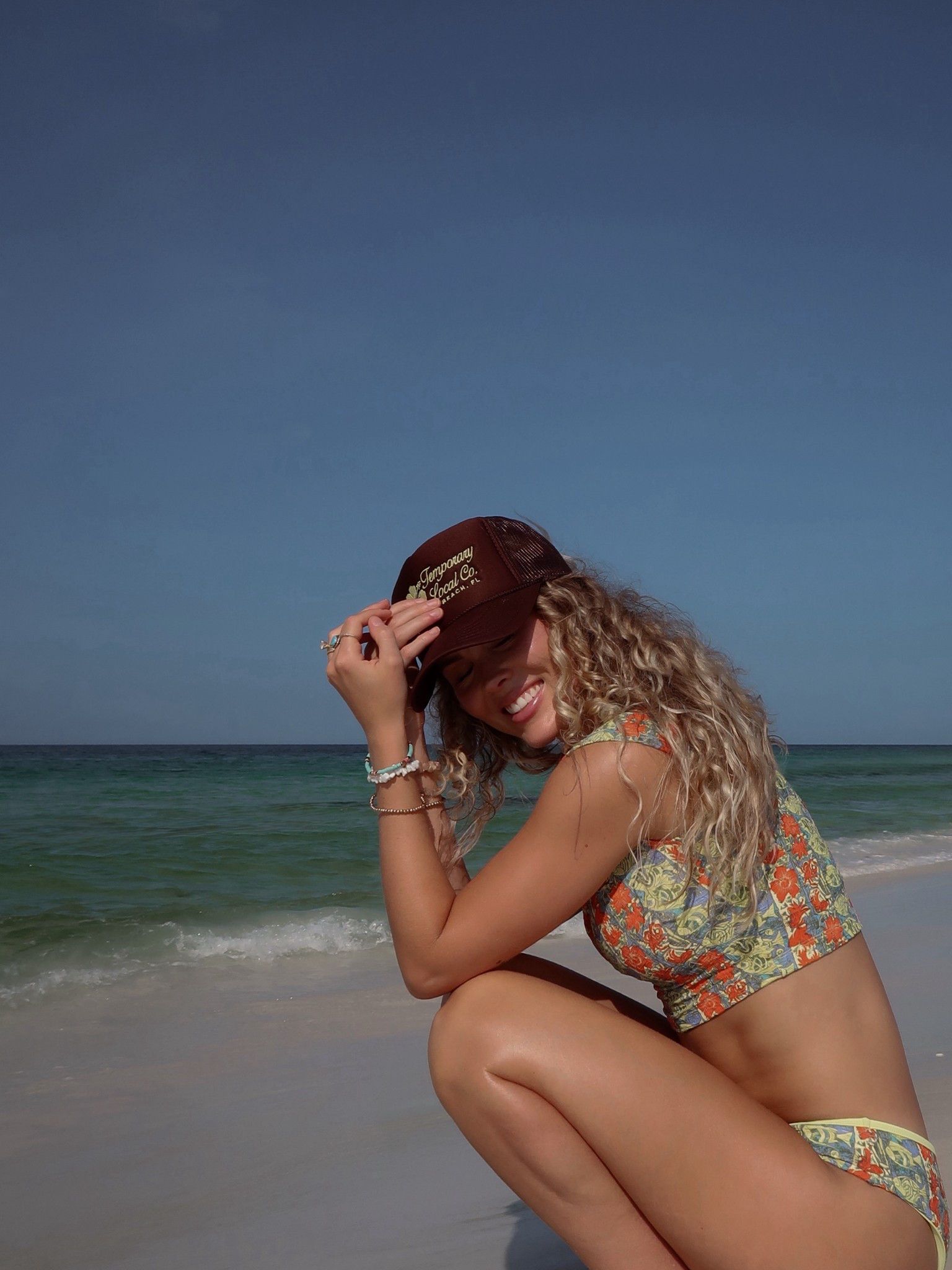 Sized way up in this swimsuit & it was worth it. Free People swim runs small. Full coverage & comfortable but still cute & colorful! Living in this at the beach all summer. Trucker hat coming soon to Temporary Local Co. 💛 

#LTKTravel #LTKSwim #LTKSeasonal