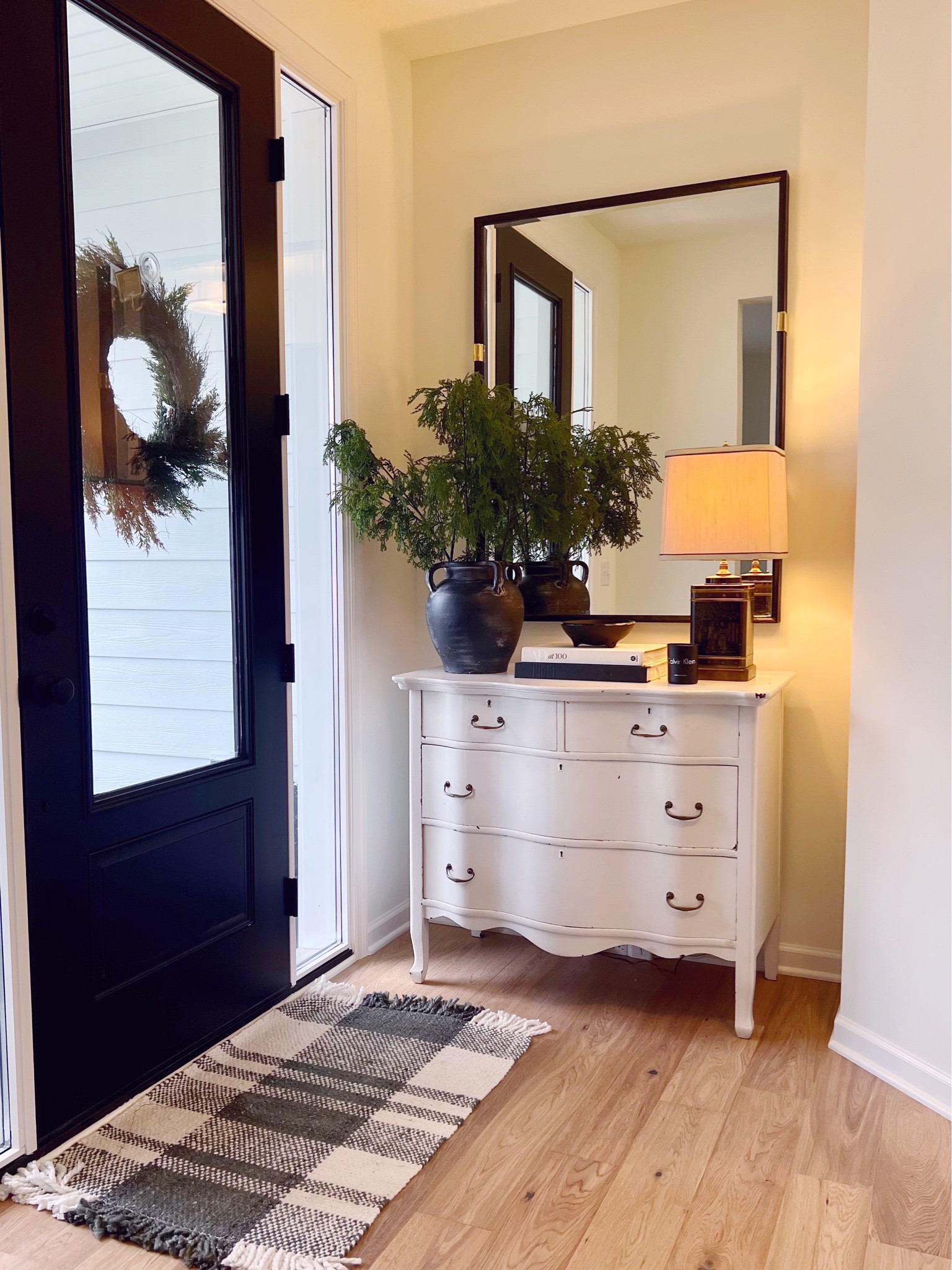 Holiday entryway! 

Vintage chest, vintage dresser, vase, stems, mirror, Chinese lamp, coffee table books 