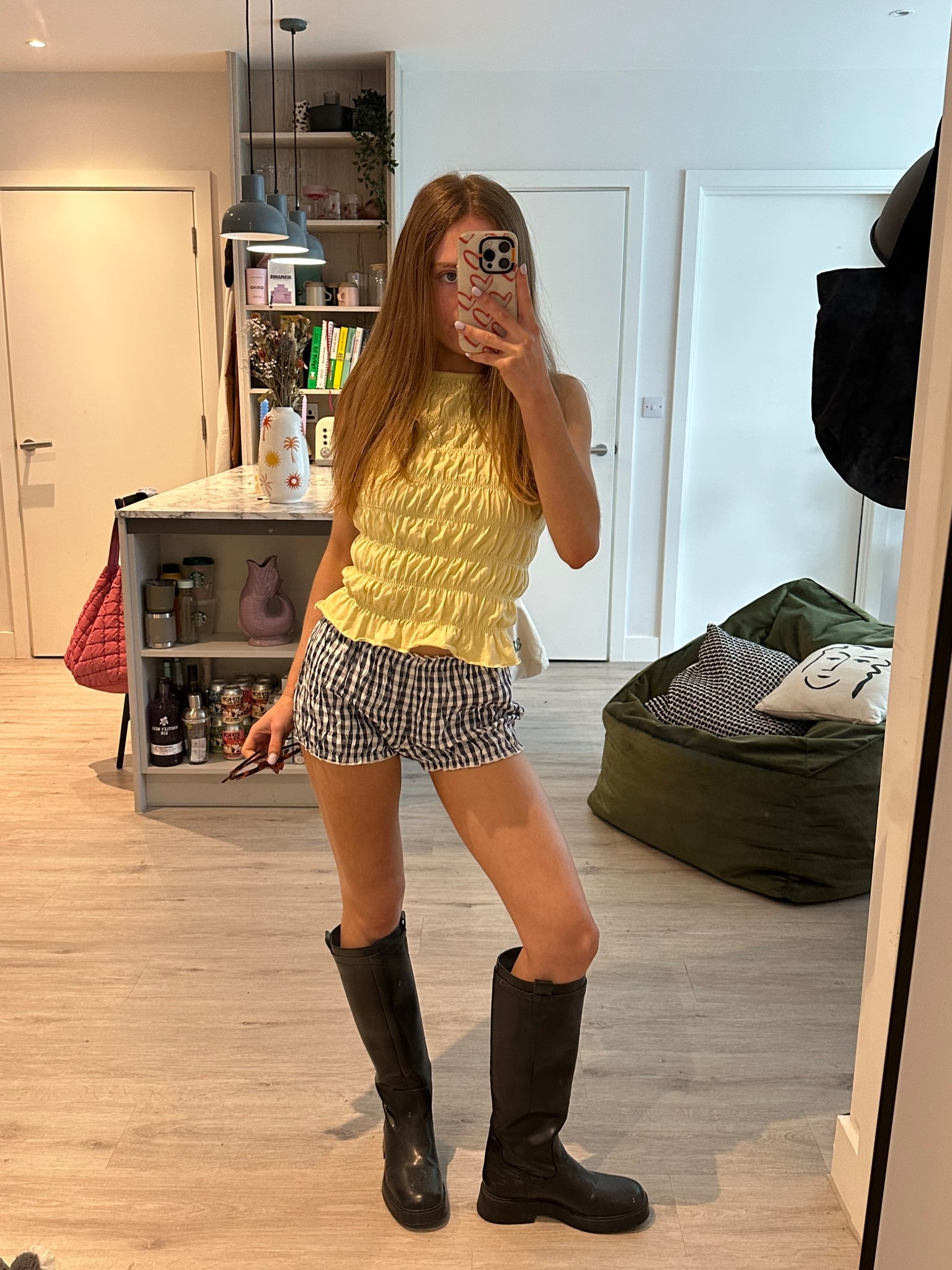 butter yellow shirred top and ruffle shorts with knee high black boots 

#LTKspring #LTKuk #LTKsummer