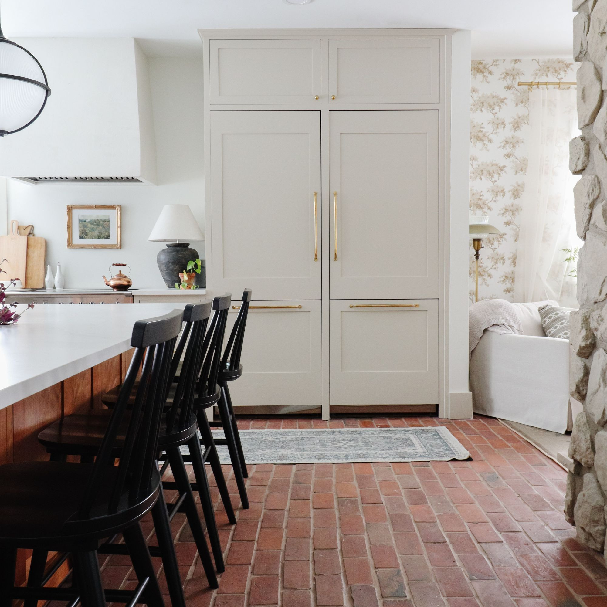 A panel-ready refrigerator was key to keeping this kitchen from feeling busy. It blends into the cabinetry, lets the island shine, and makes the space feel more like a room than a kitchen. 

 #LTKHome