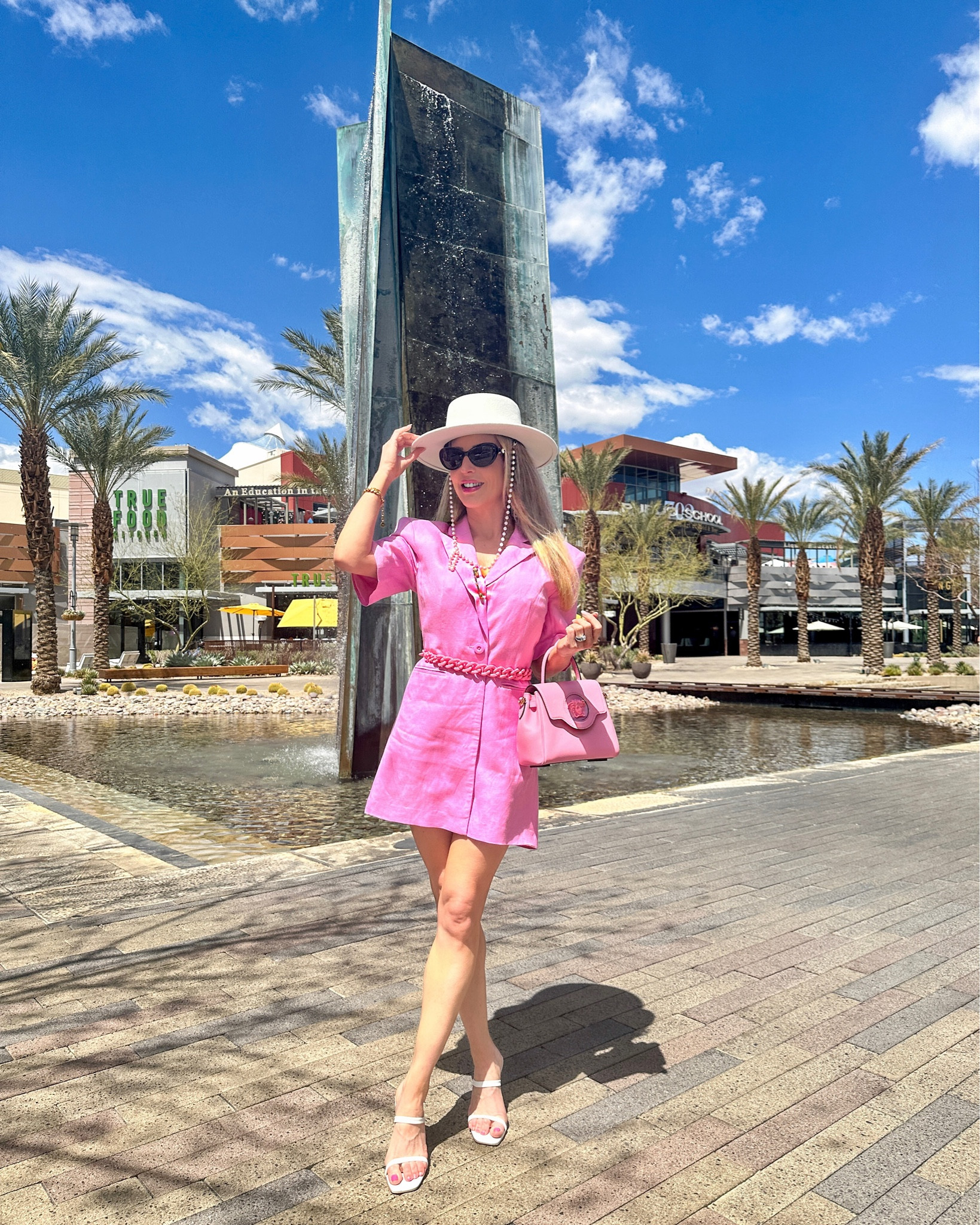 Summer brunch outfit inspo: This pink linen dress is backless and super breezy and lightweight for summer. I pinned it to be less revealing and added my bag shoulder strap to give it shape and make the look cohesive. White pyramid heels are pretty comfy. Pink Versace Medusa bag and white Stetson hat on repeat. 

#LTKSeasonal #LTKFind #LTKstyletip
