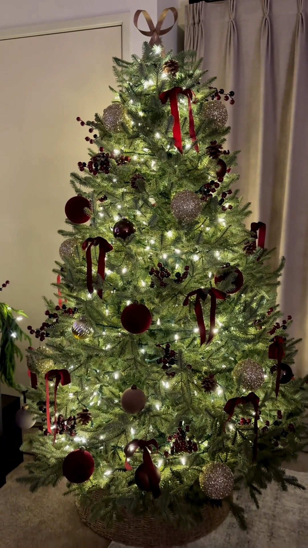 Christmas tree, tree skirt, brass bow, Norfolk pine garland, lights, Christmas lights, burgundy ribbon, velvet ribbon, burgundy ornament, gold ornament, twinkle lights 

#LTKHoliday #LTKSaleAlert #LTKHome