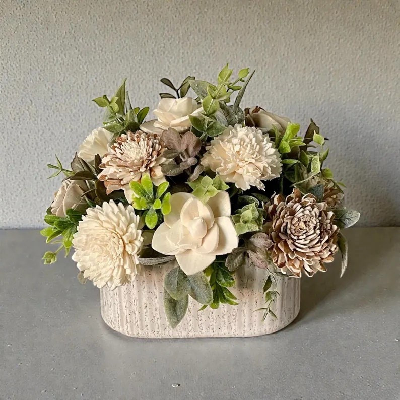 This charming sola wood flower arrangement brings natural texture and handcrafted beauty to any space. Each bloom is carefully shaped from the root of the tapioca plant, showcasing soft ivory petals with touches of natural brown for an earthy, organic look. Thoughtfully hand-dyed, fluffed, and arranged, this petite design makes a meaningful gift or a timeless decorative accent that never fades. #LTKhome #solawoodflowers #handmadehome #rusticdecor #naturaldecor #floraldecor #giftideas #homedecor #neutraldecor #artisanmade

#LTKSeasonal #LTKWedding #LTKHome