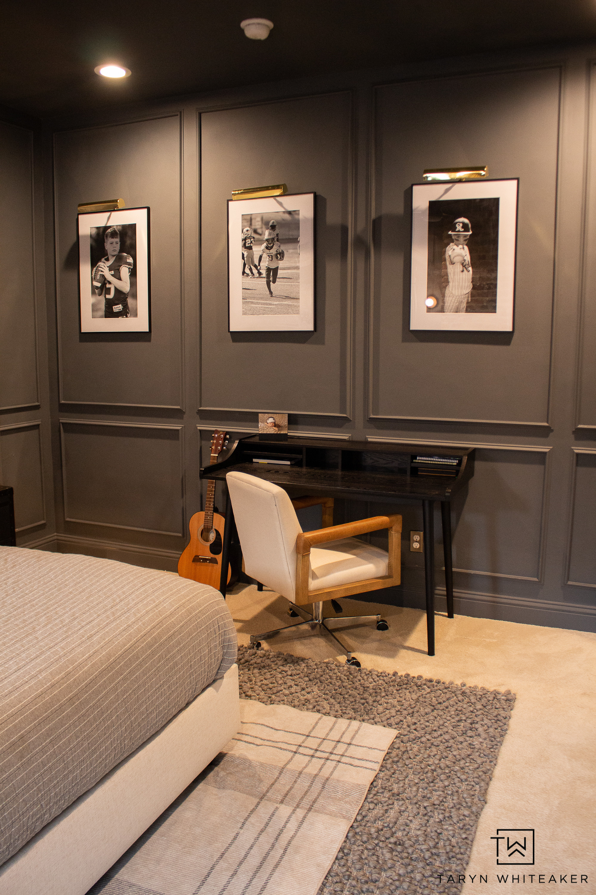 This modern bedroom makeover has such a warm, elevated feel. The dark wall paneling, framed black and white prints, and brass picture lights create a bold focal point, while the textured rugs and soft bedding keep the space cozy. The small desk setup is perfect for a simple workspace without overwhelming the room.
Sharing the exact lighting, rugs, bedding, and decor pieces to help you recreate this modern, moody bedroom look.

#LTKKids #LTKHome #LTKSeasonal
