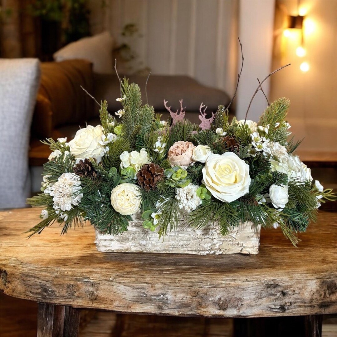 Bring cozy cabin charm into your home with this winter-inspired centerpiece, designed with rustic elegance in mind. Featuring soft white roses and peonies nestled among pine, eucalyptus, and natural birch twigs, this arrangement captures the beauty of a snowy woodland. The two metal deer accents add a warm, whimsical touch—perfect for a dining table, coffee table, or seasonal display in a mountain or farmhouse setting. #LTKhome #winterdecor #cabinstyle #rusticdecor #floralcenterpiece #cozyhome #holidaydecor #etsyhome

#LTKHome #LTKWedding #LTKSeasonal