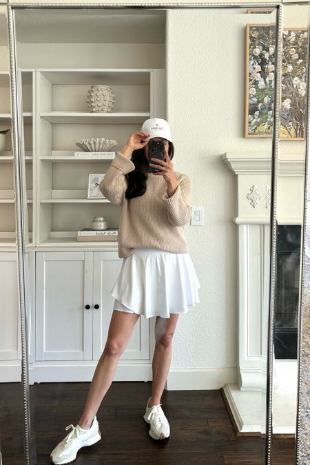 A look that takes you from running errands to the pickleball court. 
1. Jenni Kayne cotton fisherman sweater in a size small. I’m also linking an almost identical sweater from Quince.
2. New Balance 327 sneakers. These are so comfortable and run true to size. 
3. White active skirt. Mine is Lululemon. 

Tennis skirt
Golf skirt 
Active outfit 

#LTKShoeCrush #LTKOver40 #LTKActive